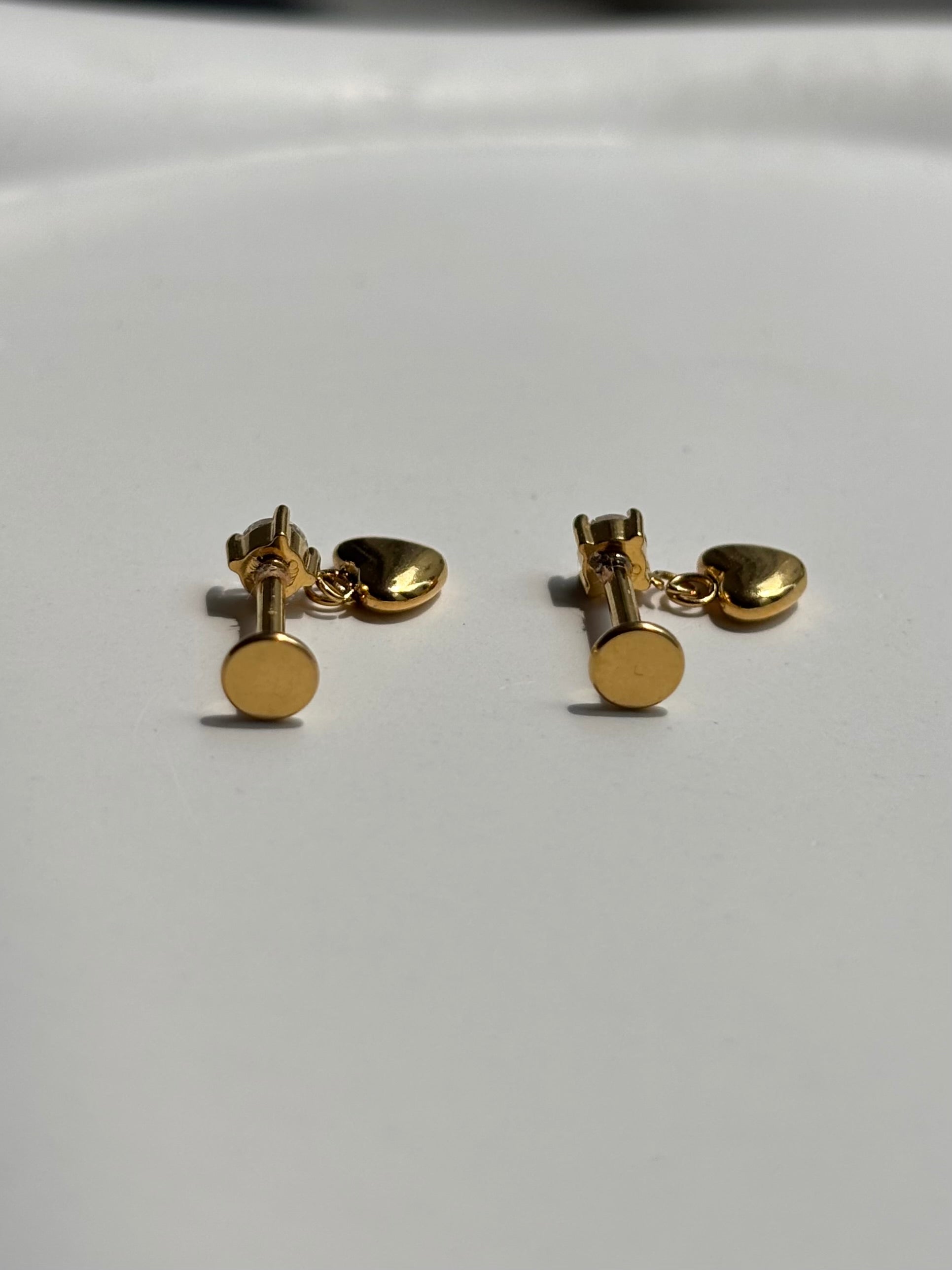 Close-up of heart drop flat-back stud earrings �? 18k gold-plated sleep-friendly heart drop studs for casual wear.