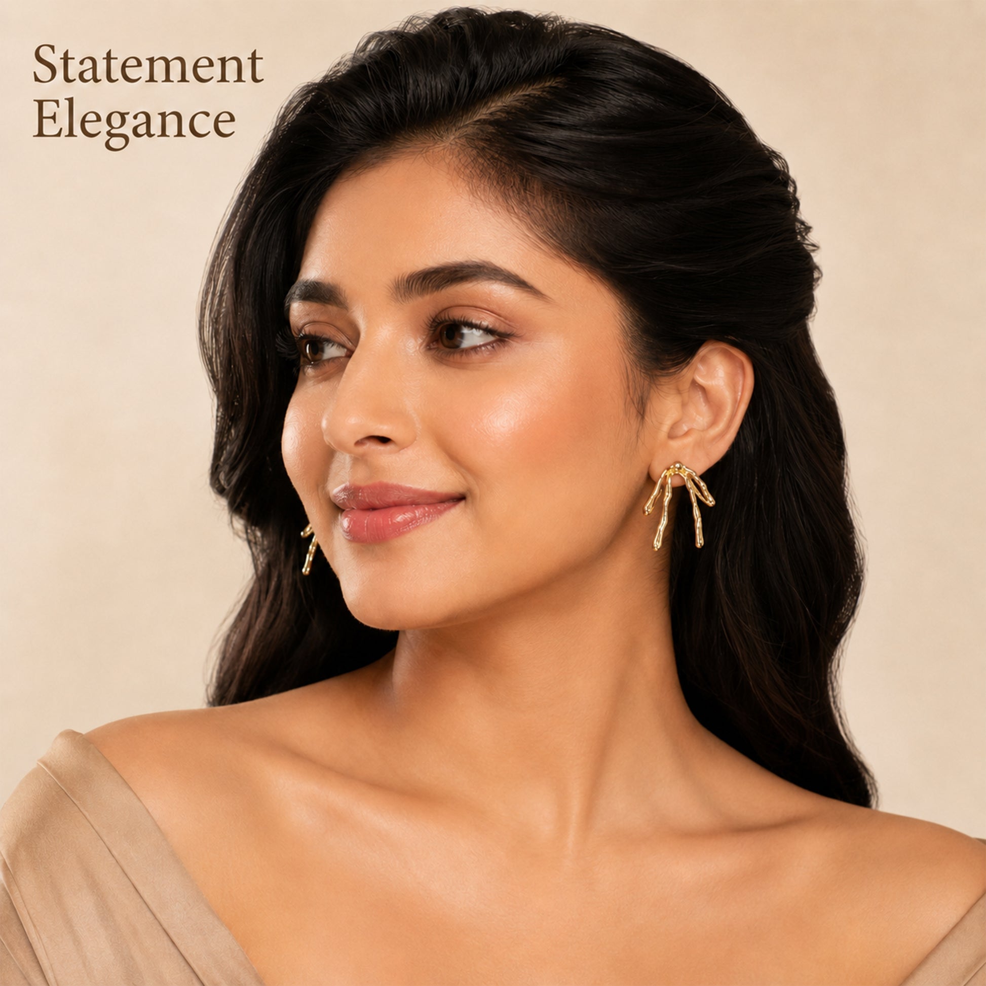 Close-up view of gold branch earrings with textured finish