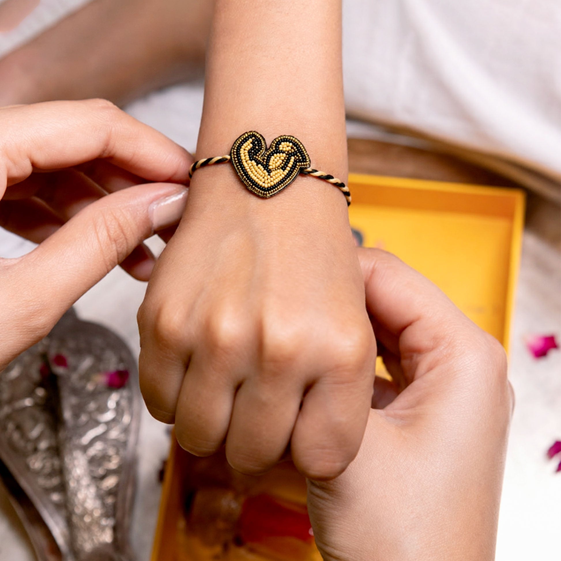 Close-up view of love designer rakhi with bead detailing