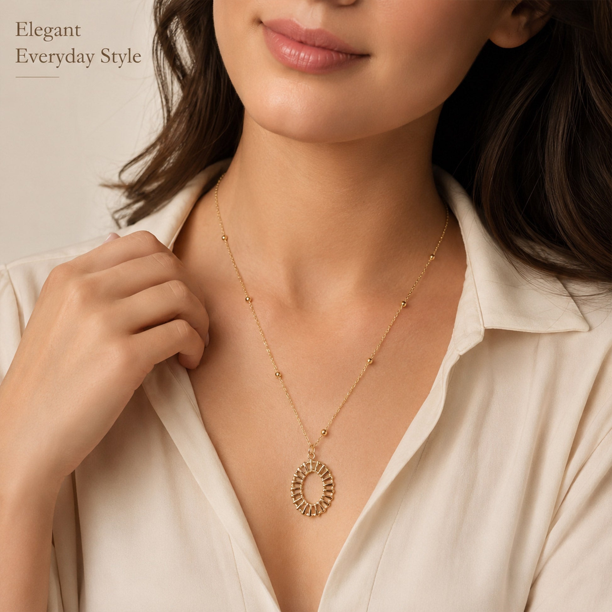 Close-up view of gold open oval pendant with geometric detailing