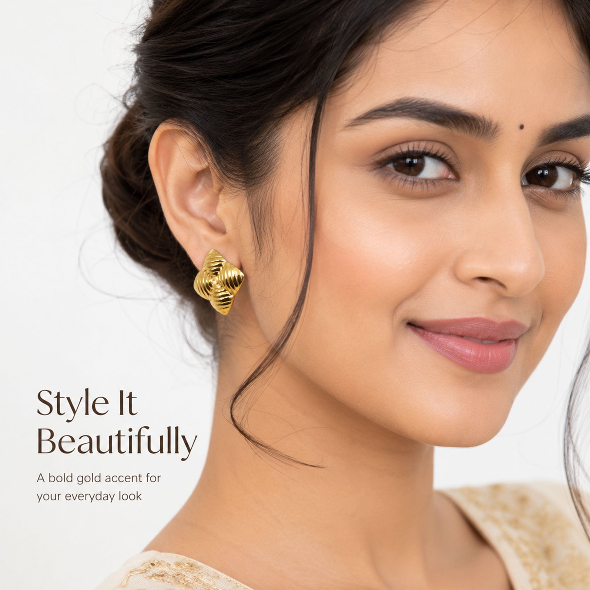 Close-up view of gold star earrings with sculpted ribbed texture