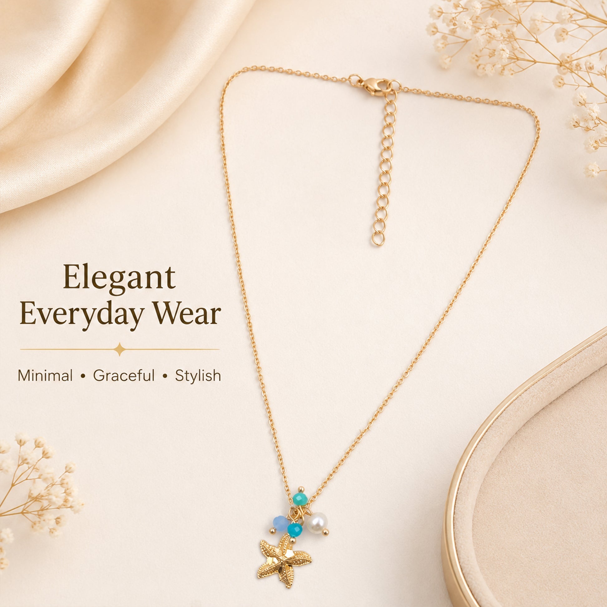 Close-up view of gold starfish necklace with blue beads and pearl
