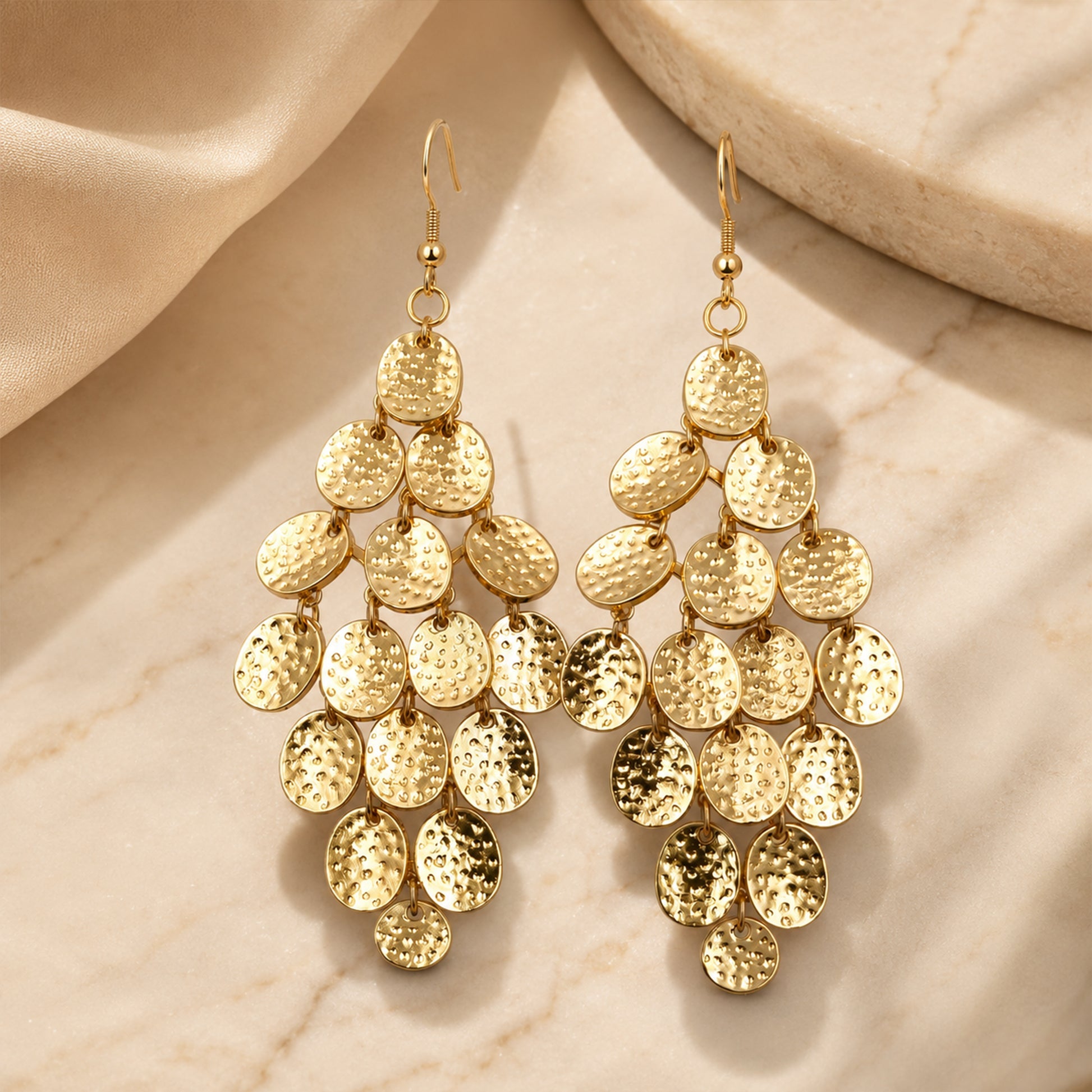 Detailed view of hammered gold disc statement earrings