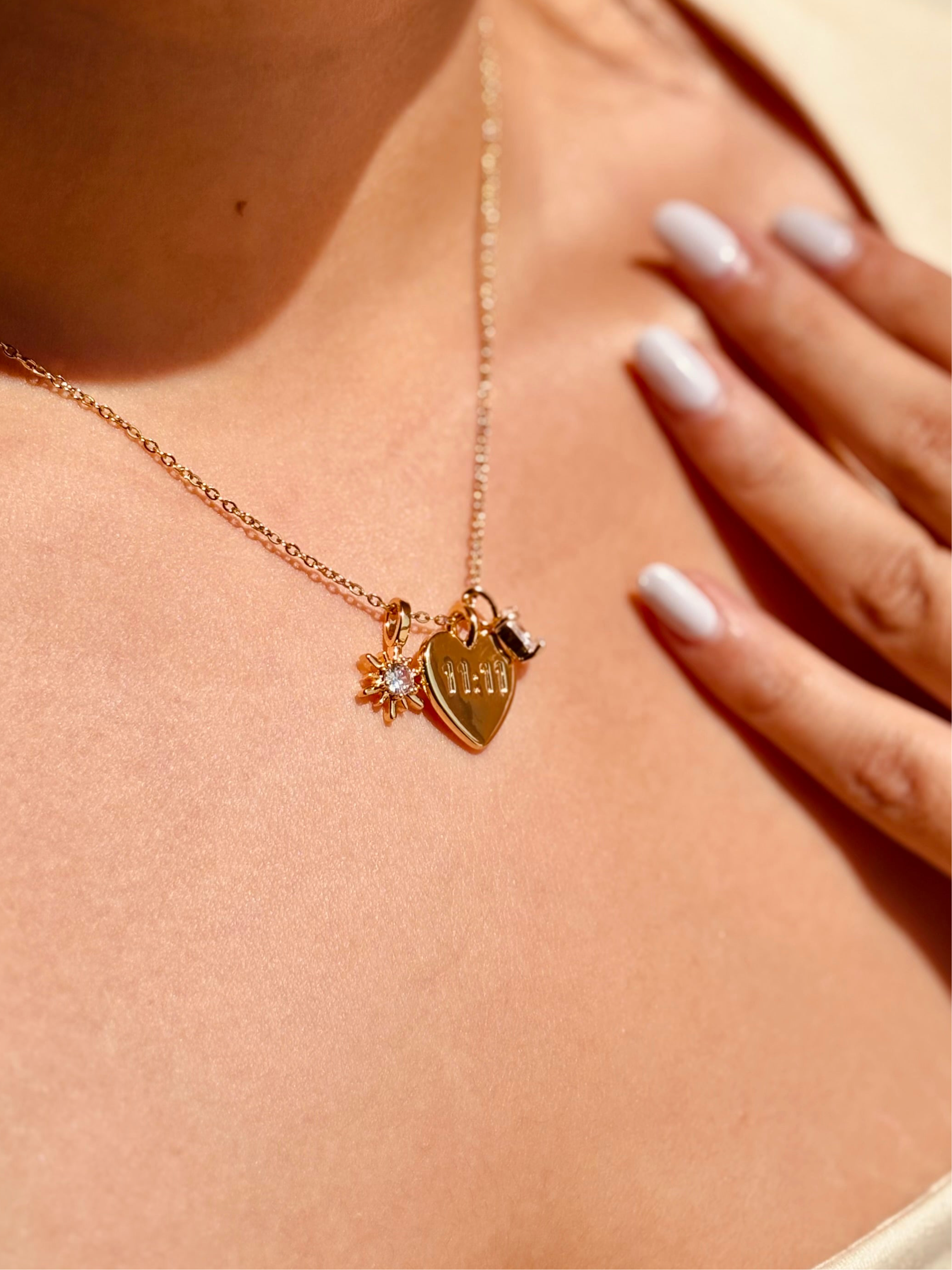 Close-up of 11:11 charm necklace �? dressy white stone manifestation pendant on gold-plated chain for daily wear.