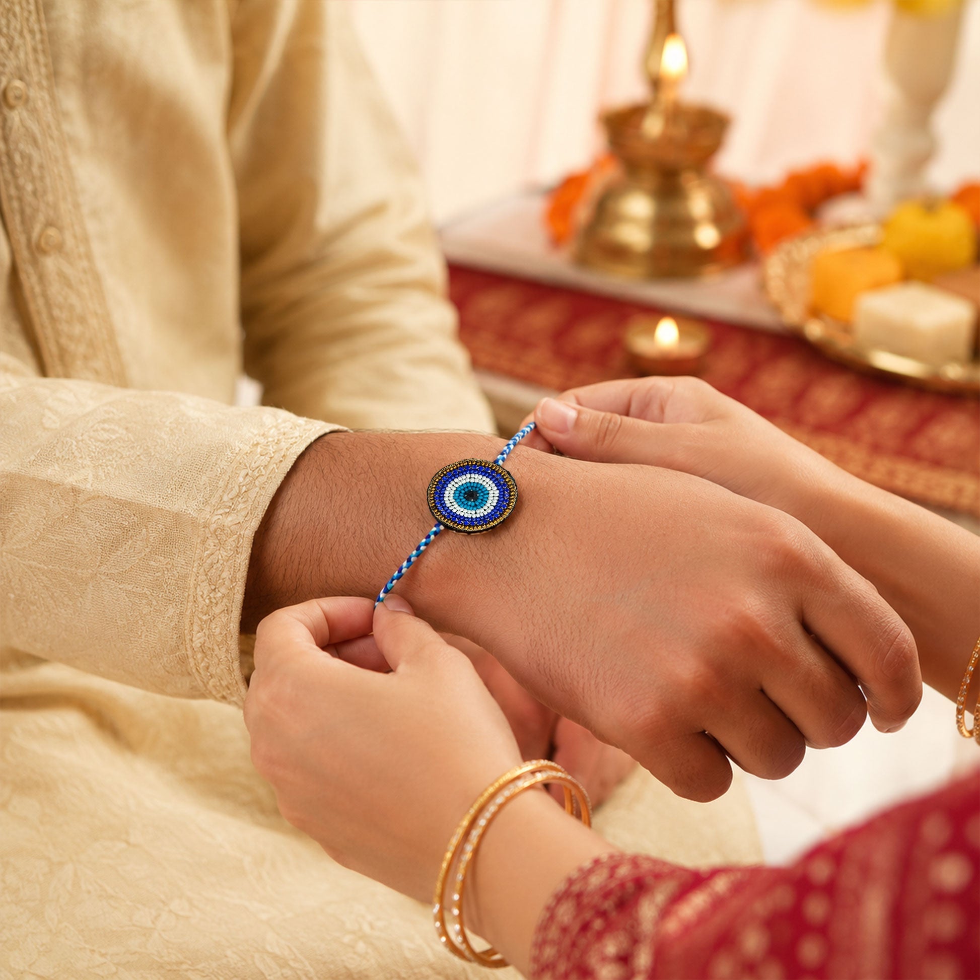 Multicolor braided thread rakhi with round evil eye design