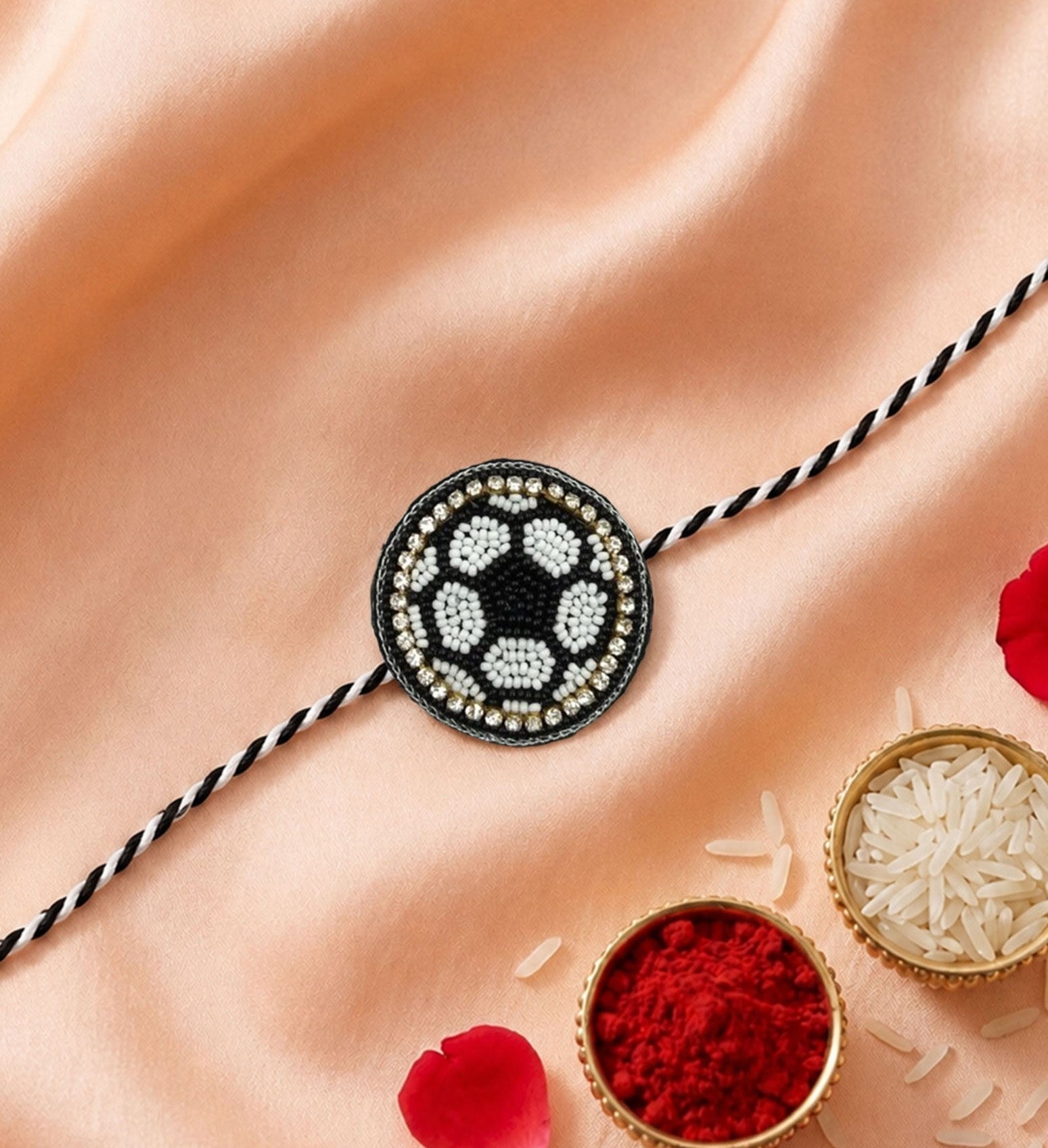 Close-up view of designer rakhi with round stone centerpiece