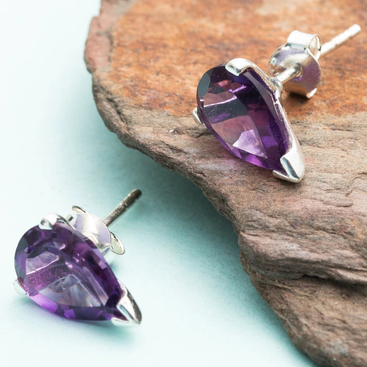 925 Silver Eartops with drop shape faceted Amethyst set by hand with Prongs and push closure.