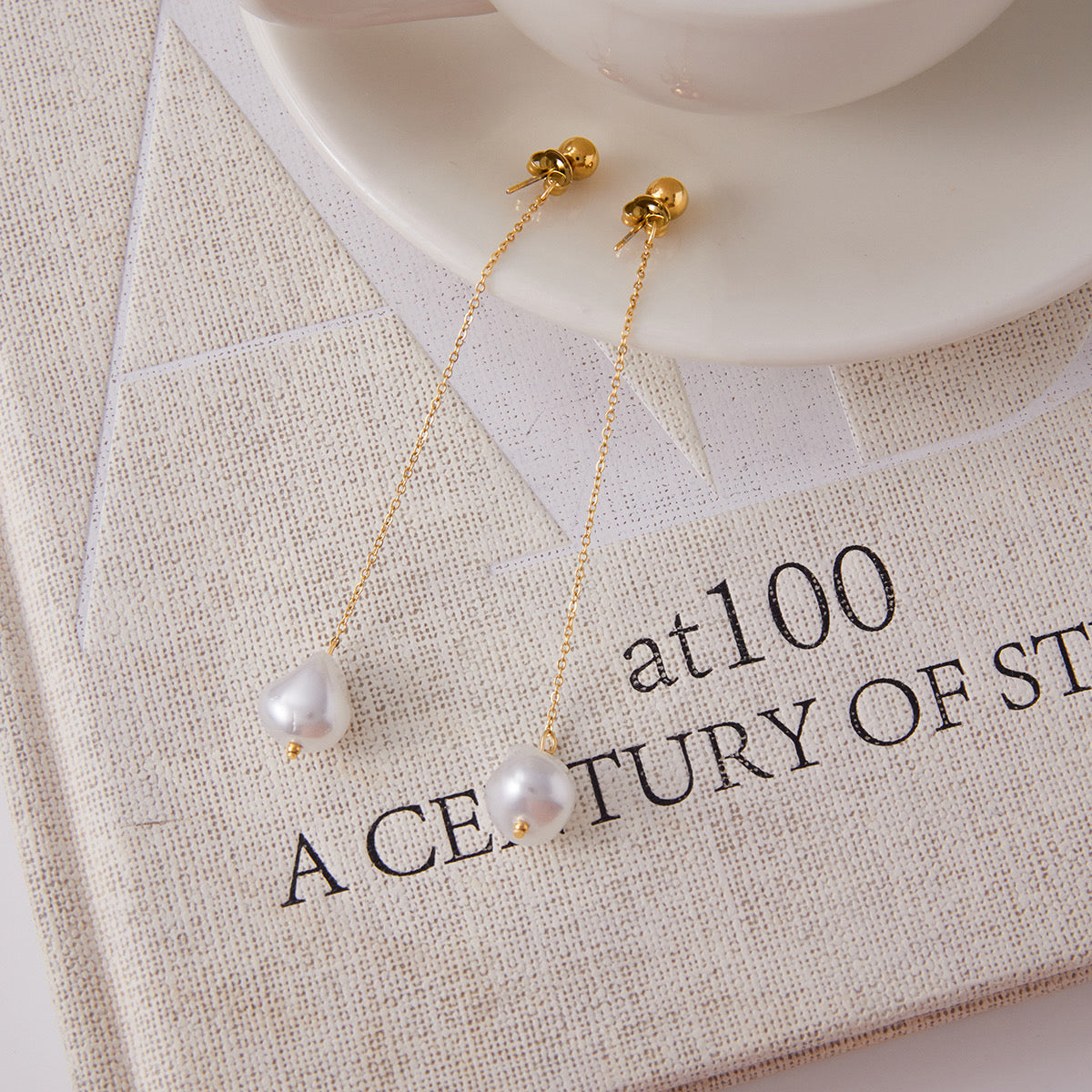 Pair of 18k gold-plated pearl drops styled view �? elegant pearl earrings for bridal and gifting.