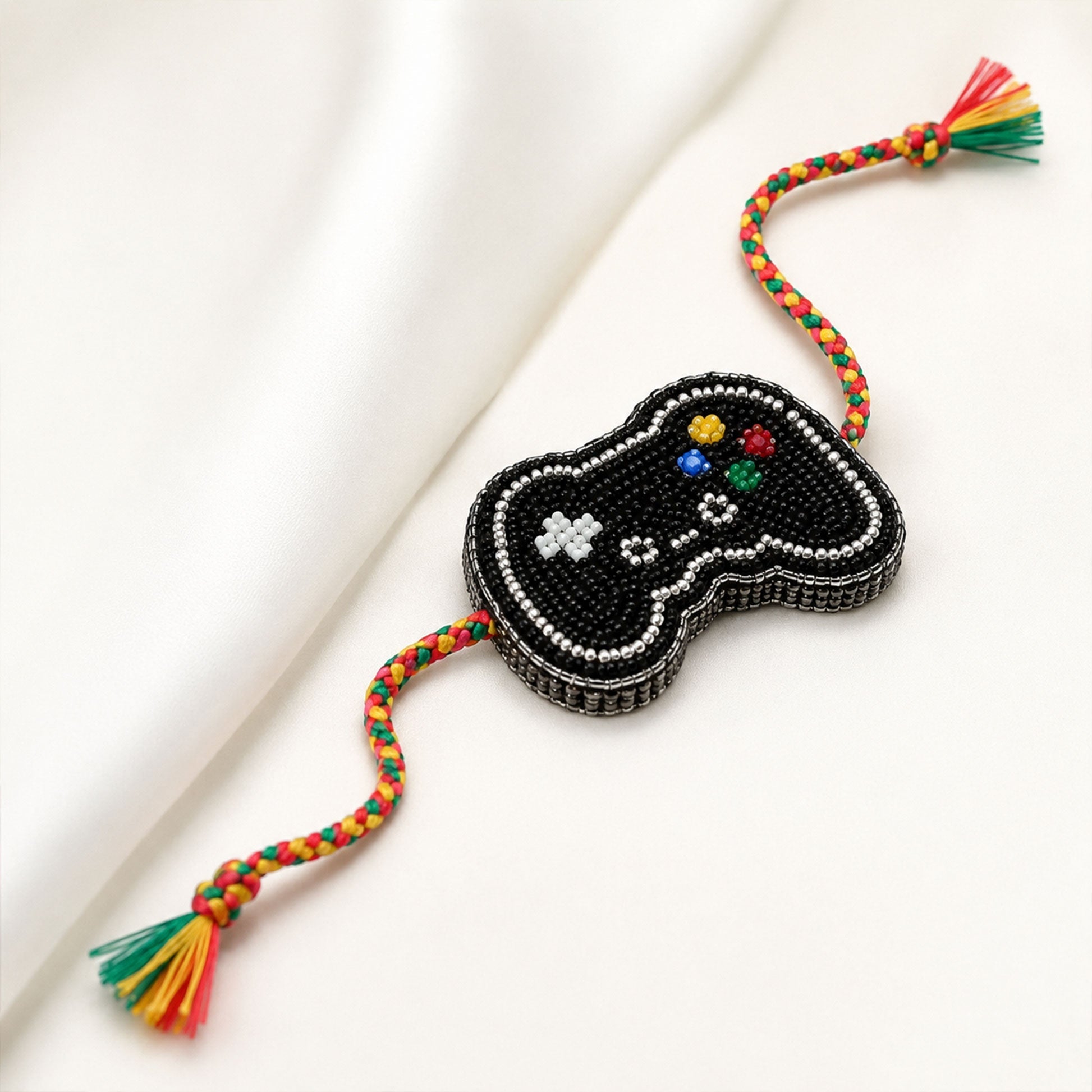 Black game controller designer rakhi on white background