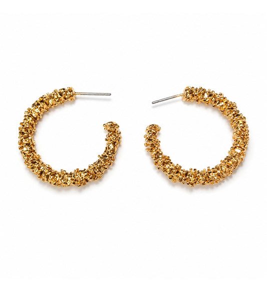 Gold textured hoop earrings pair on white background