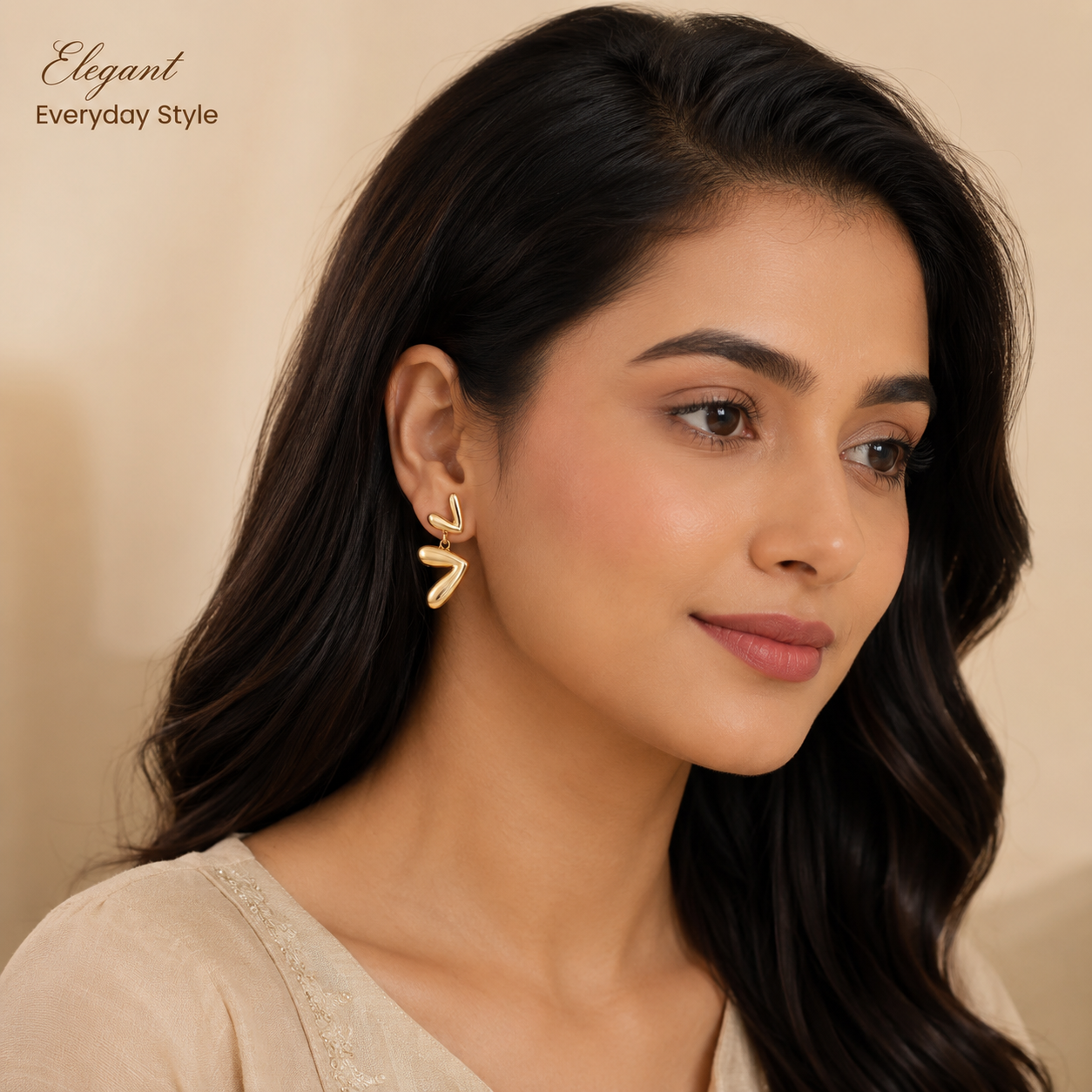 Close-up view of rose gold earrings with sculpted curved design