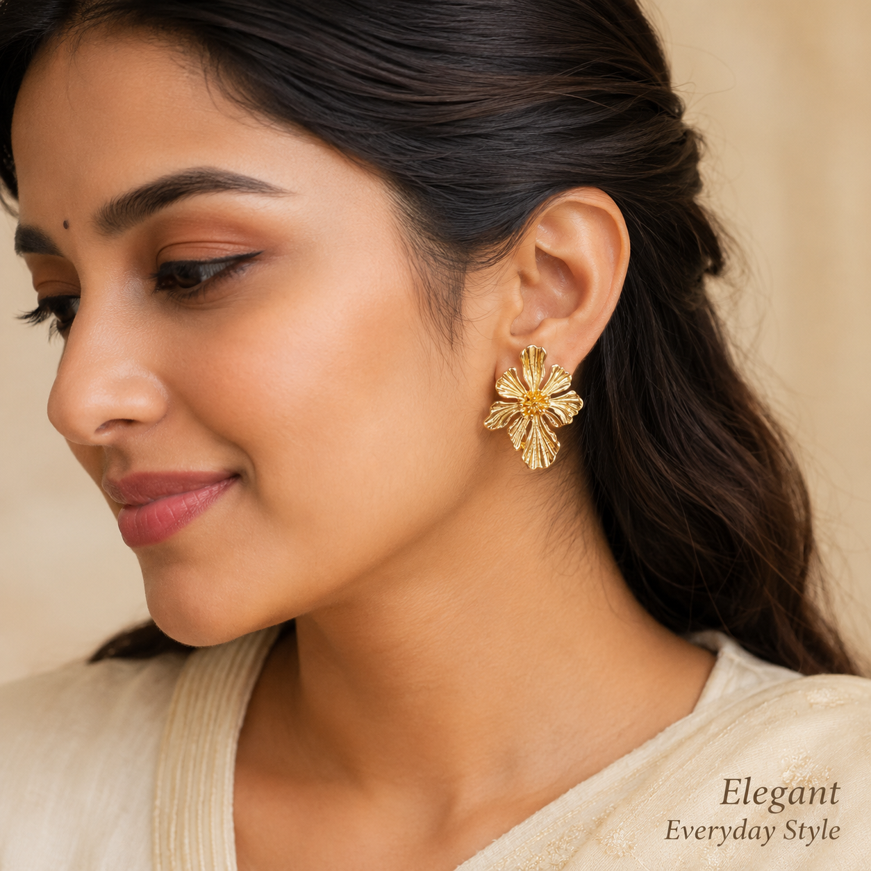 Close-up view of gold flower earrings with sculpted petal design