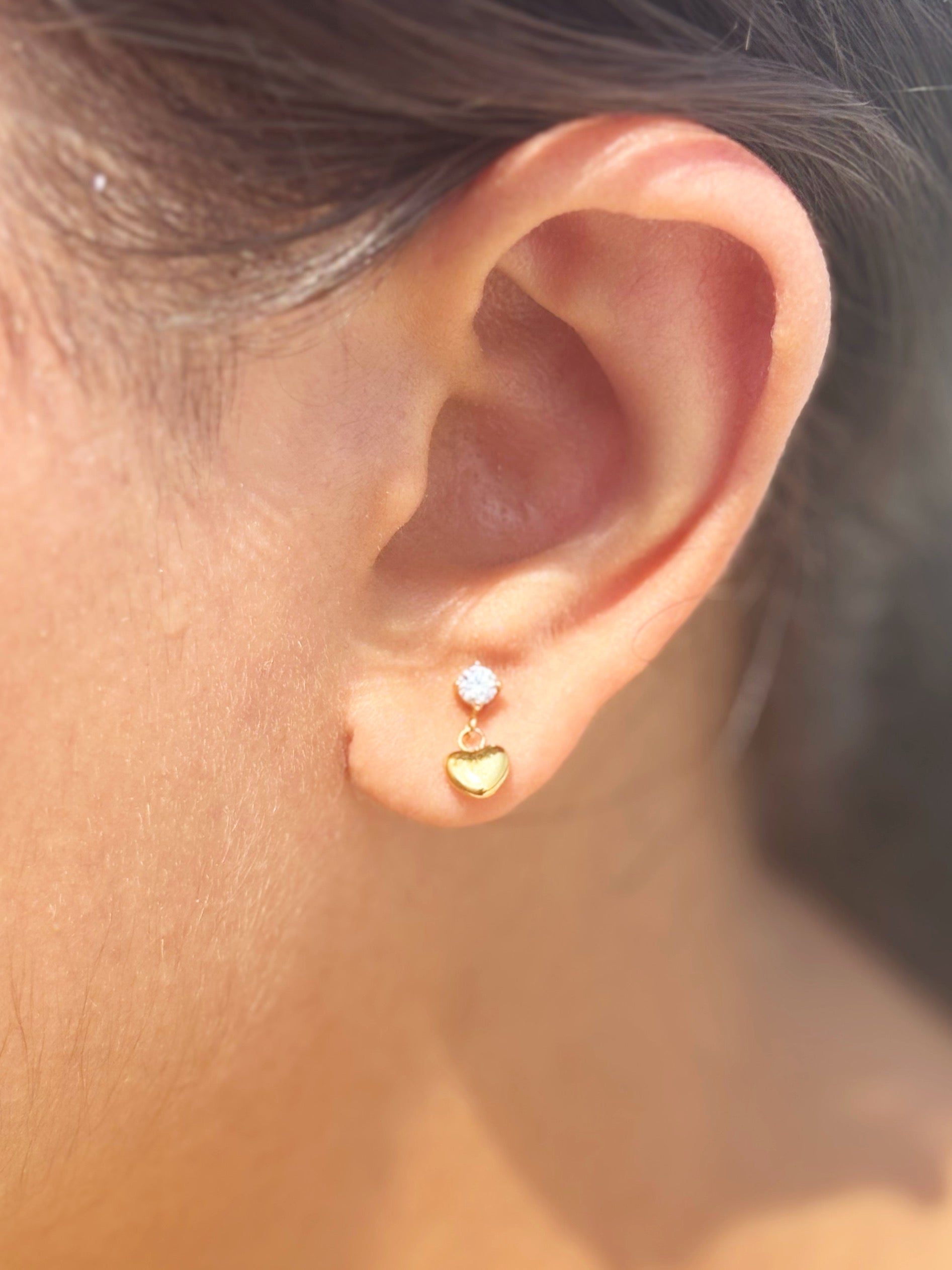 Detail shot of heart drop flat-back stud earrings �? 18k gold-plated minimal heart drop studs for everyday and gifting.