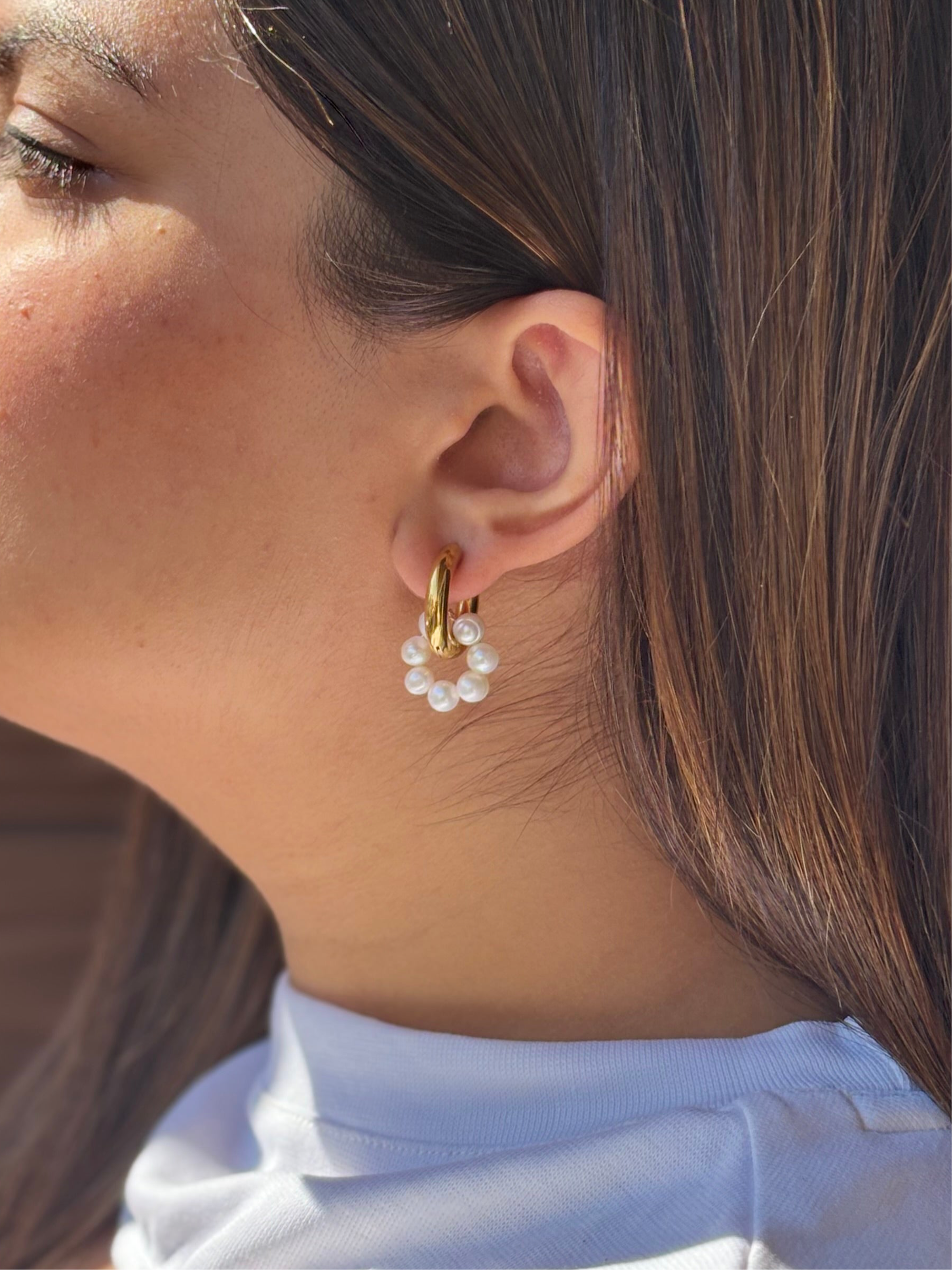 Close-up of Alina pearl drops �? 18k gold-plated freshwater pearl drops for evening looks.