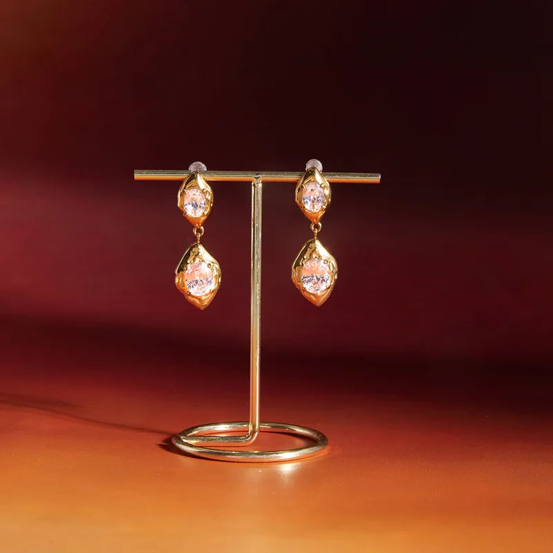 Gold stone drop earrings detail �? statement 18k gold-plated drops for ethnic and party outfits.