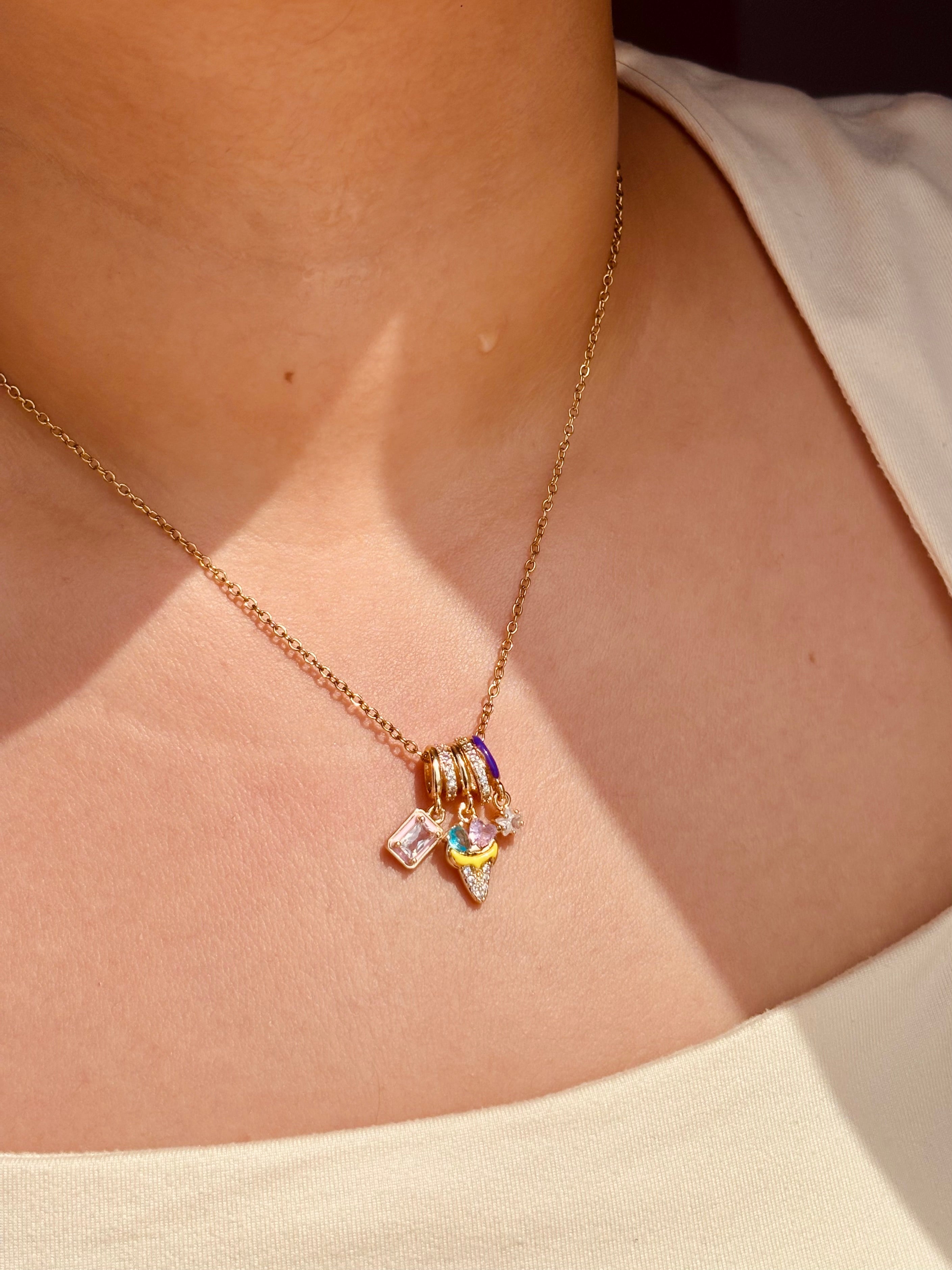 Close-up of Ice Bloom pendant �? playful radiant enamel charm on gold-plated chain for festive wear.