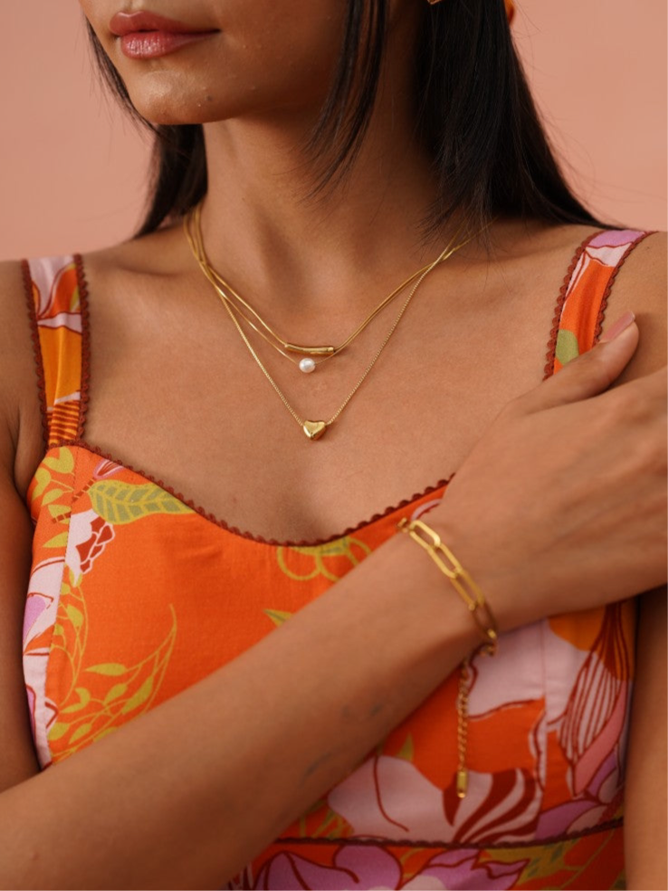 Styled view of double layer heart necklace �? 18k gold-plated chic romantic pearl heart necklace for evening and gifting.