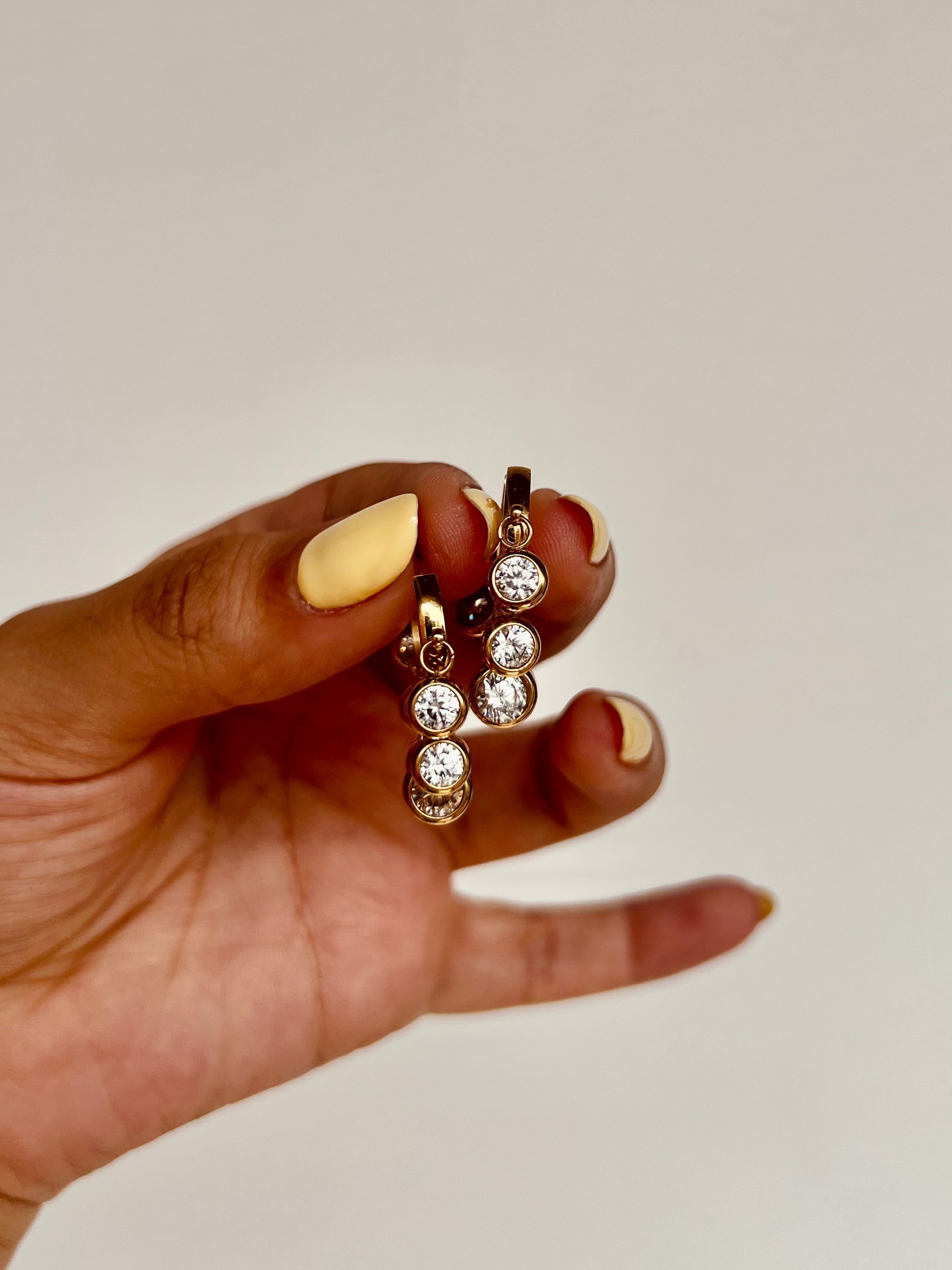 Close-up of 18k gold-plated everyday hoops �? lightweight, anti-tarnish stainless steel design for daily wear.