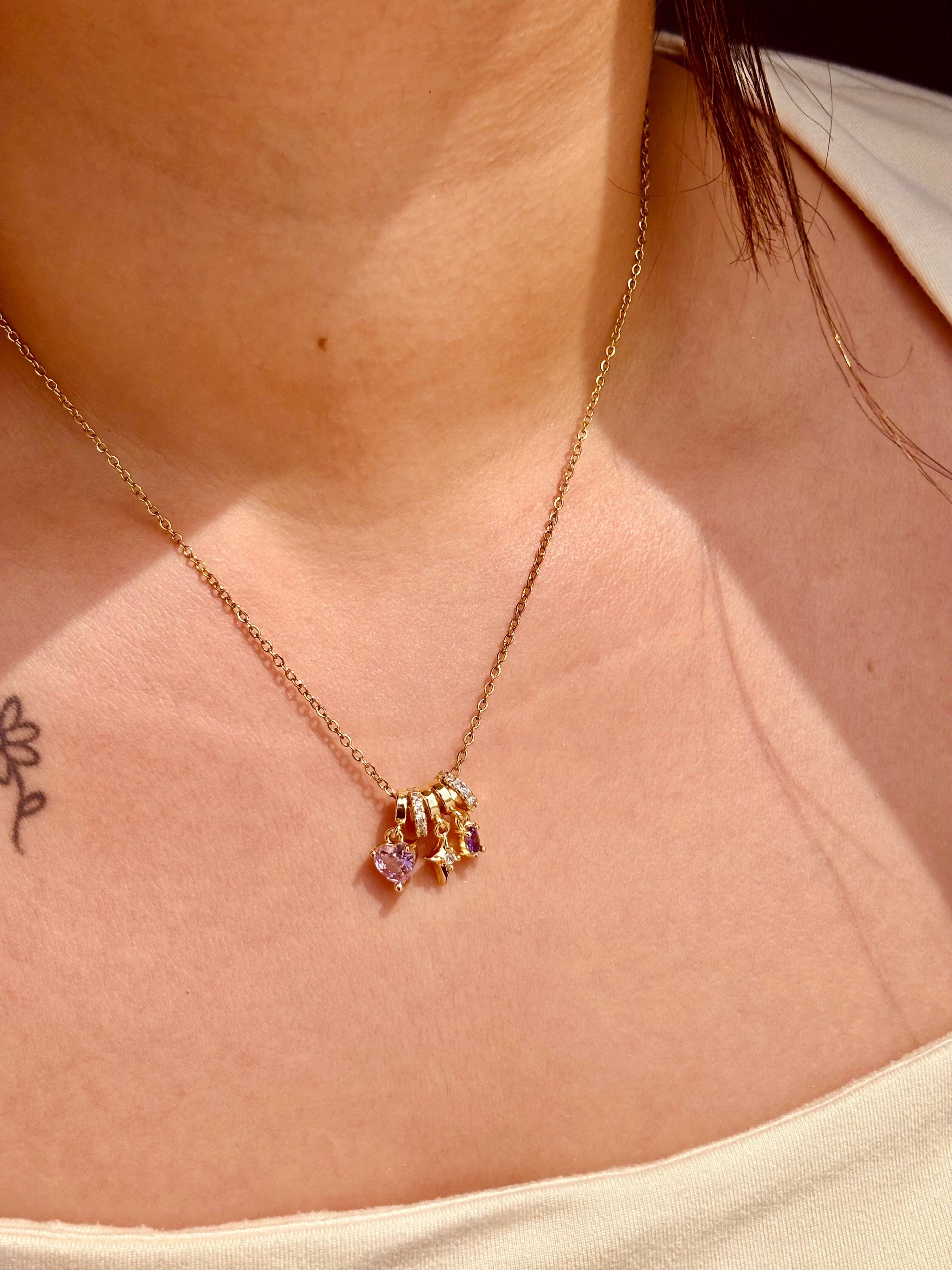 Close-up of Heart Bloom pendant necklace �? chic gemstone heart charm on gold-plated chain for everyday wear.