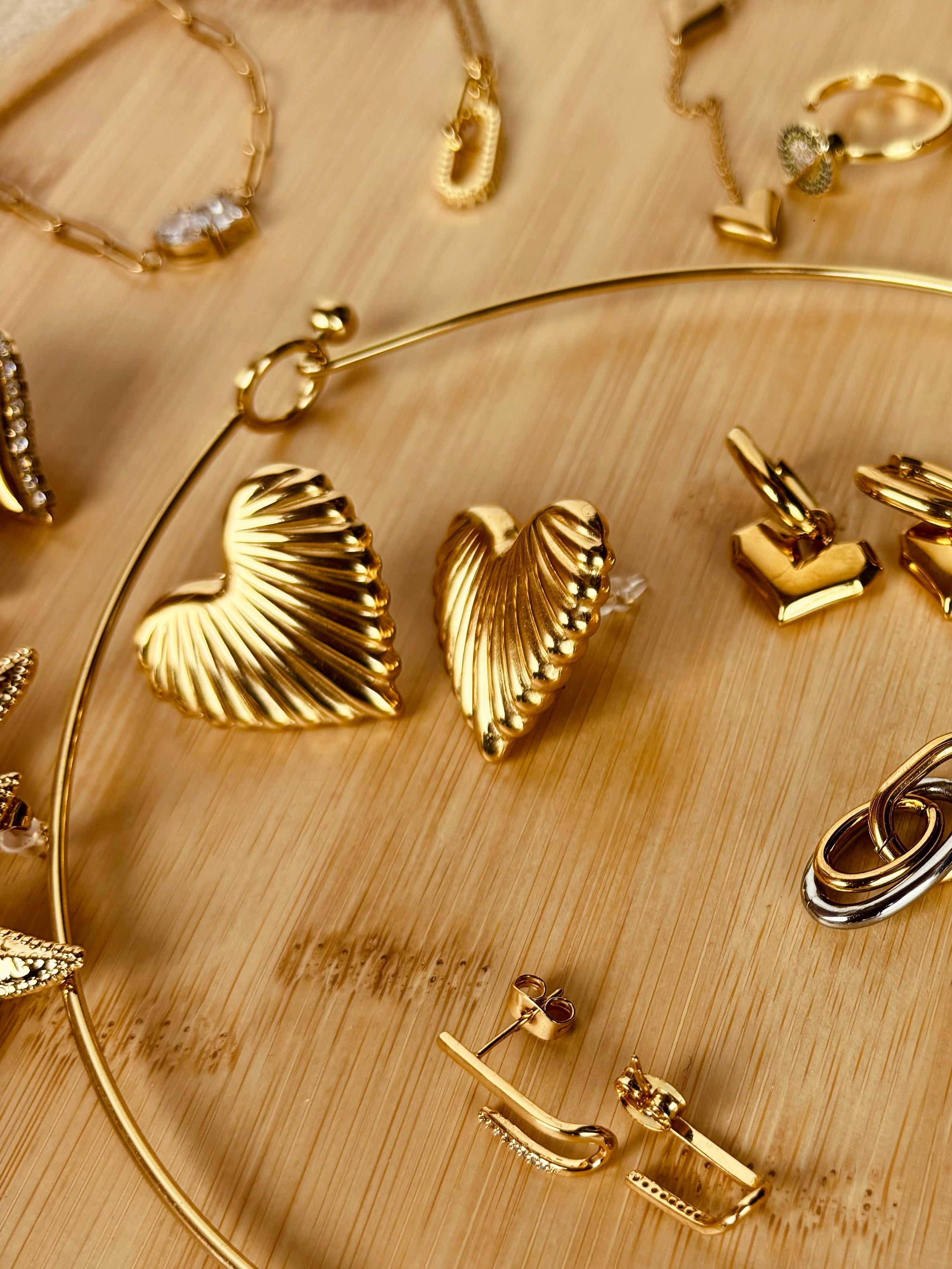 Heart stud earrings displayed together �? 18k gold-plated sweet minimal heart studs for everyday wear.