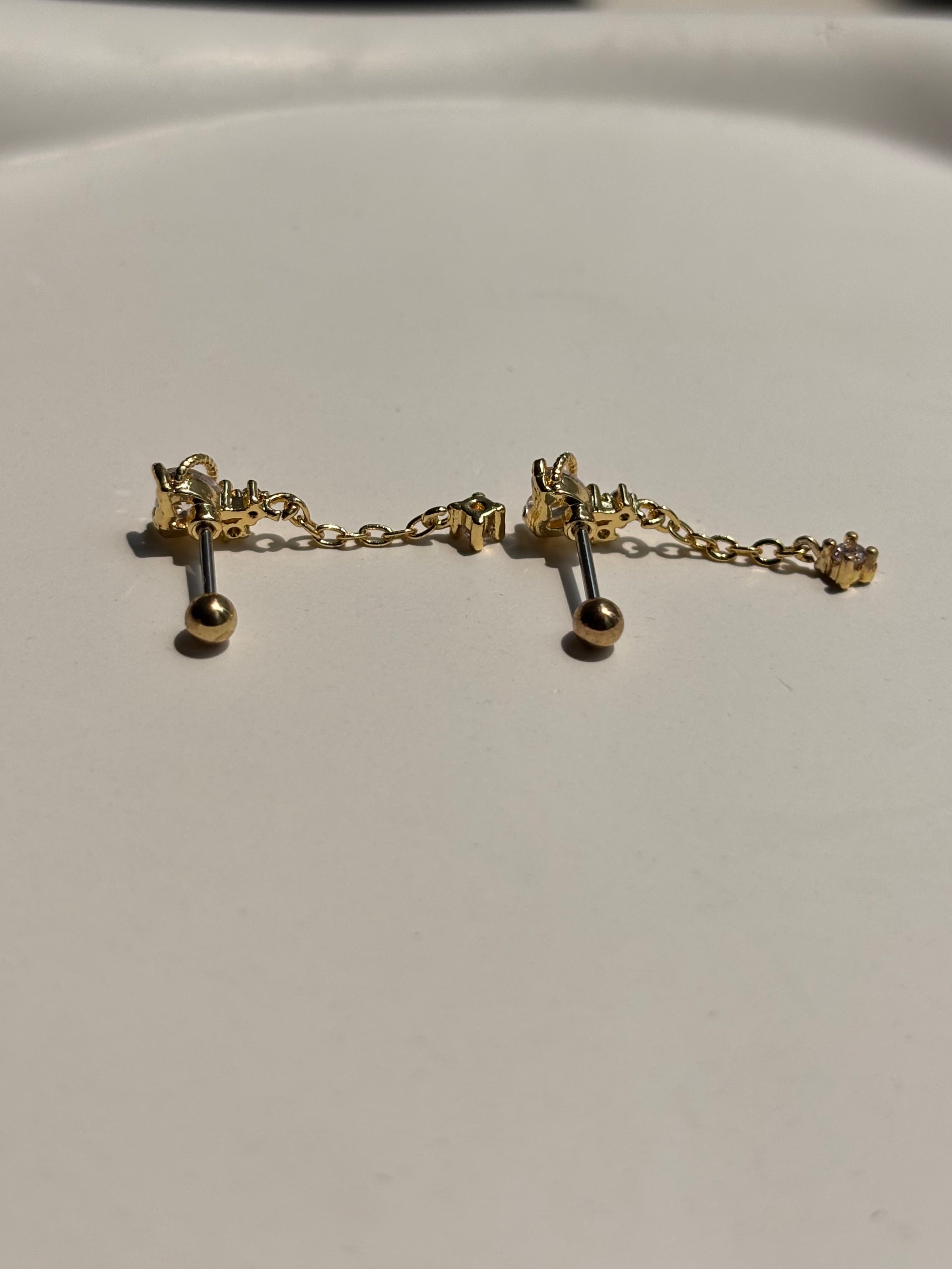 Close-up of stone drop ball-back stud earrings �? 18k gold-plated sleep-friendly stone drop studs for casual wear.