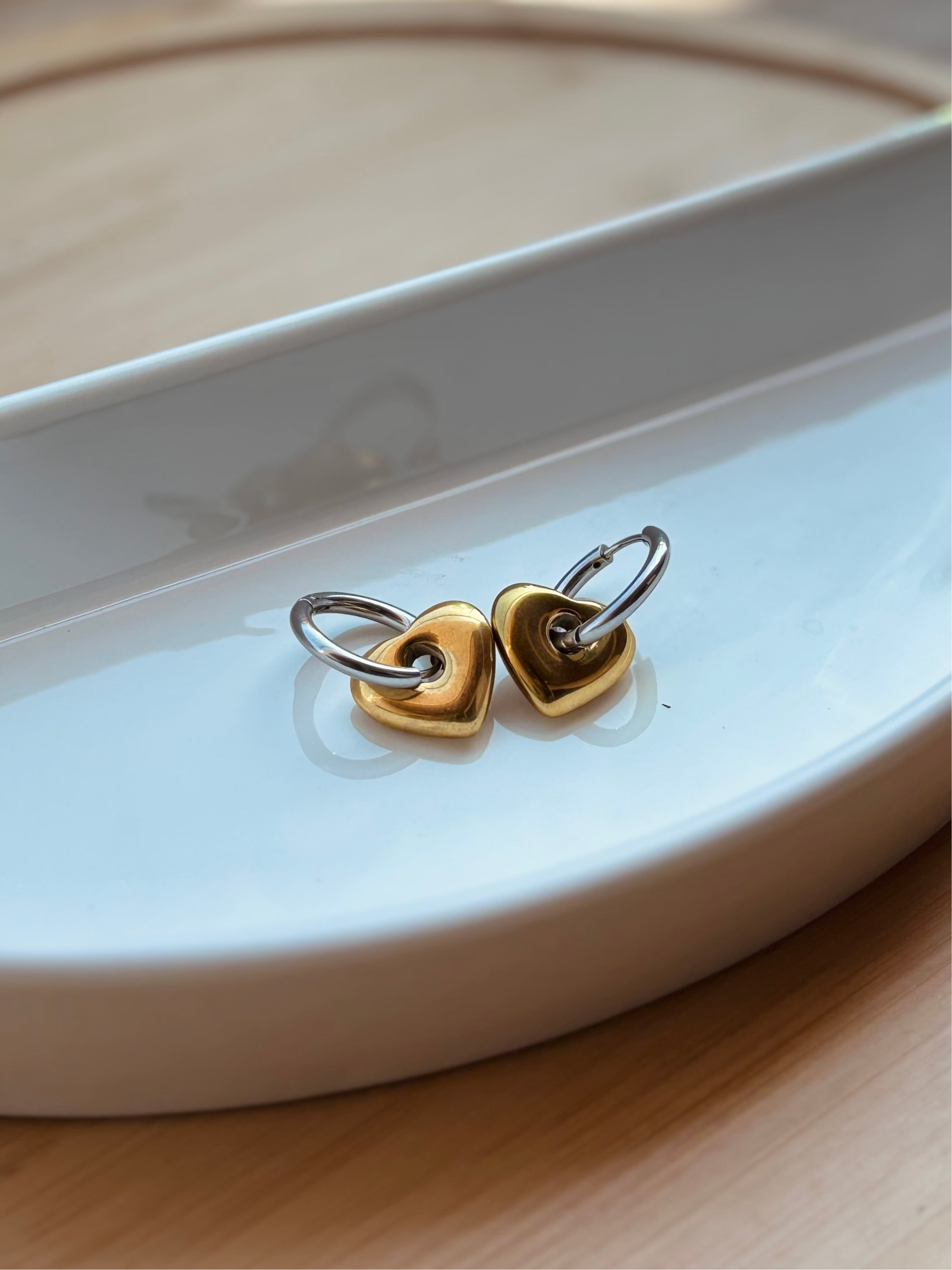 Pair of Love heart hoop earrings �? 18k gold-plated bold heart hoops for evening and gifting.