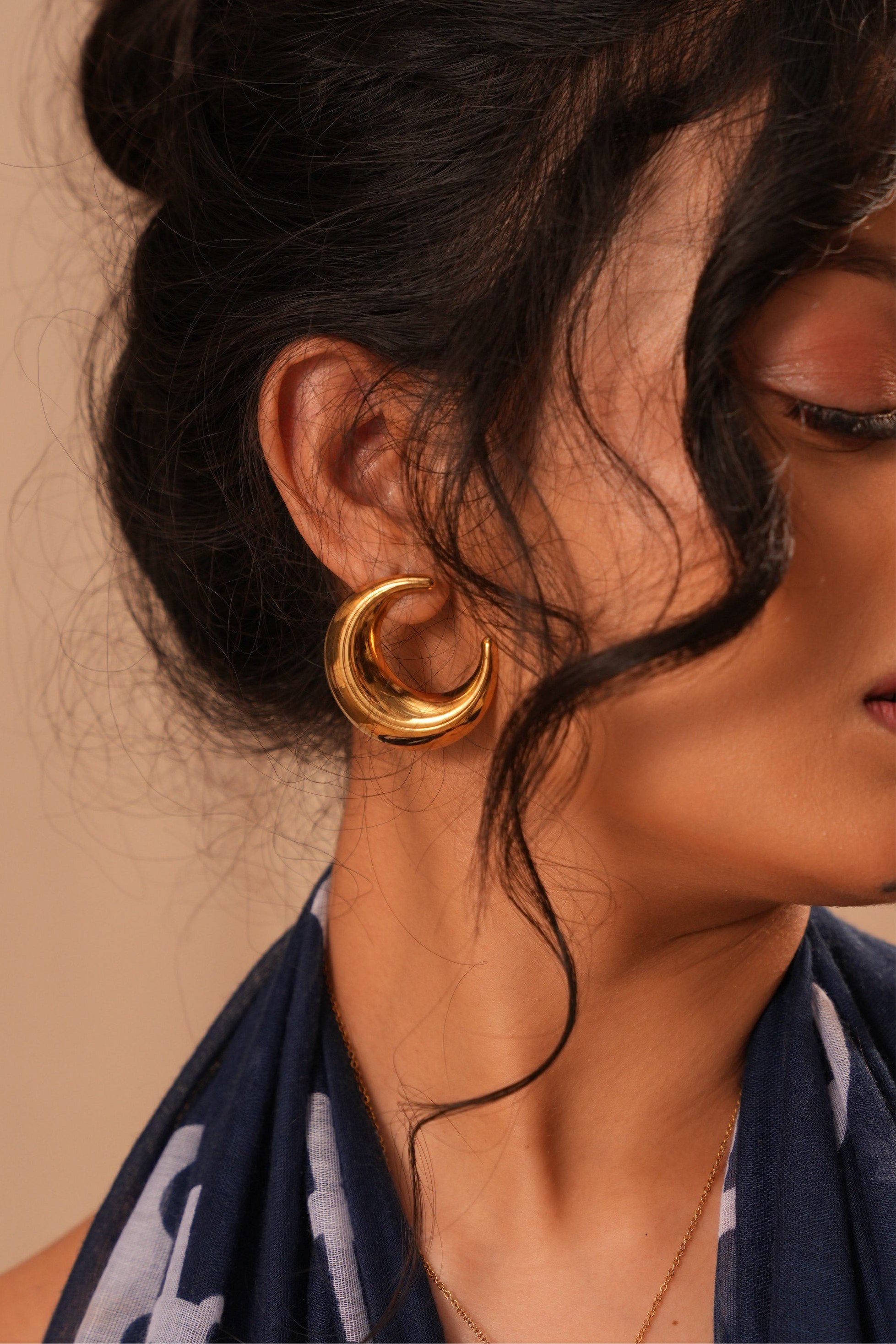 Detail shot of Moon studs �? 18k gold-plated celestial moon hoops for everyday styling.
