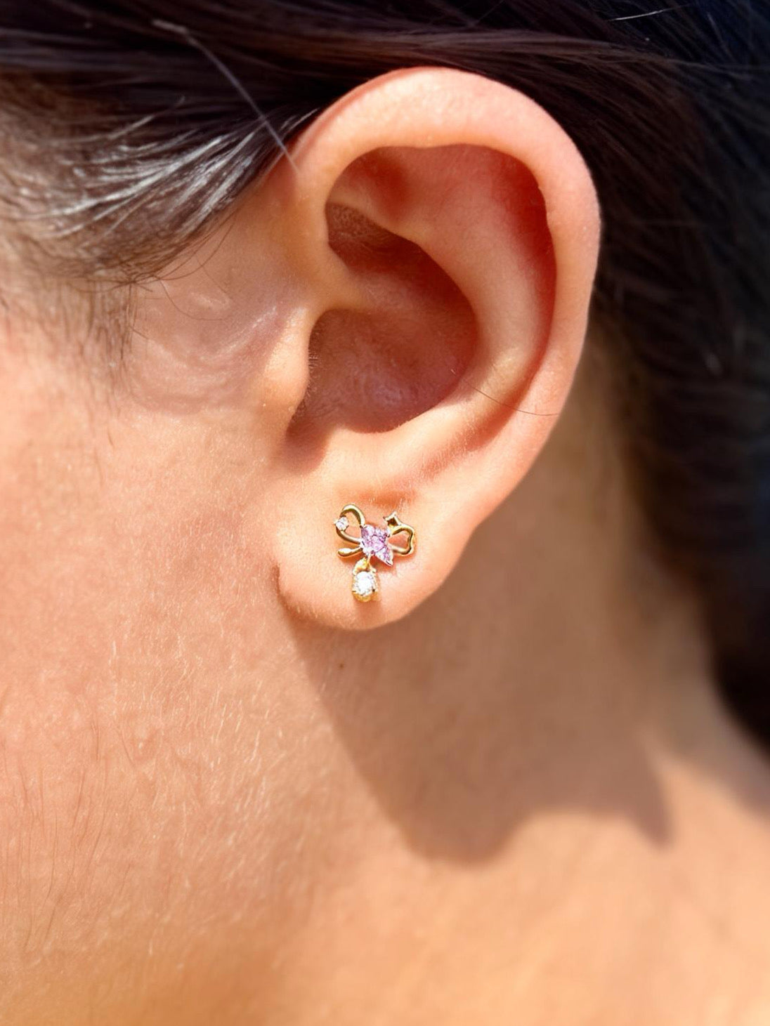 Detail shot of bow ball-back earrings �? gold-plated sweet bow studs for casual styling and gifting.