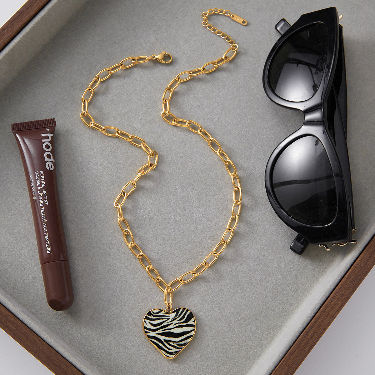 Close-up of zebra heart pendant �? 18k gold-plated heart-shape pendant for evening and gifting.
