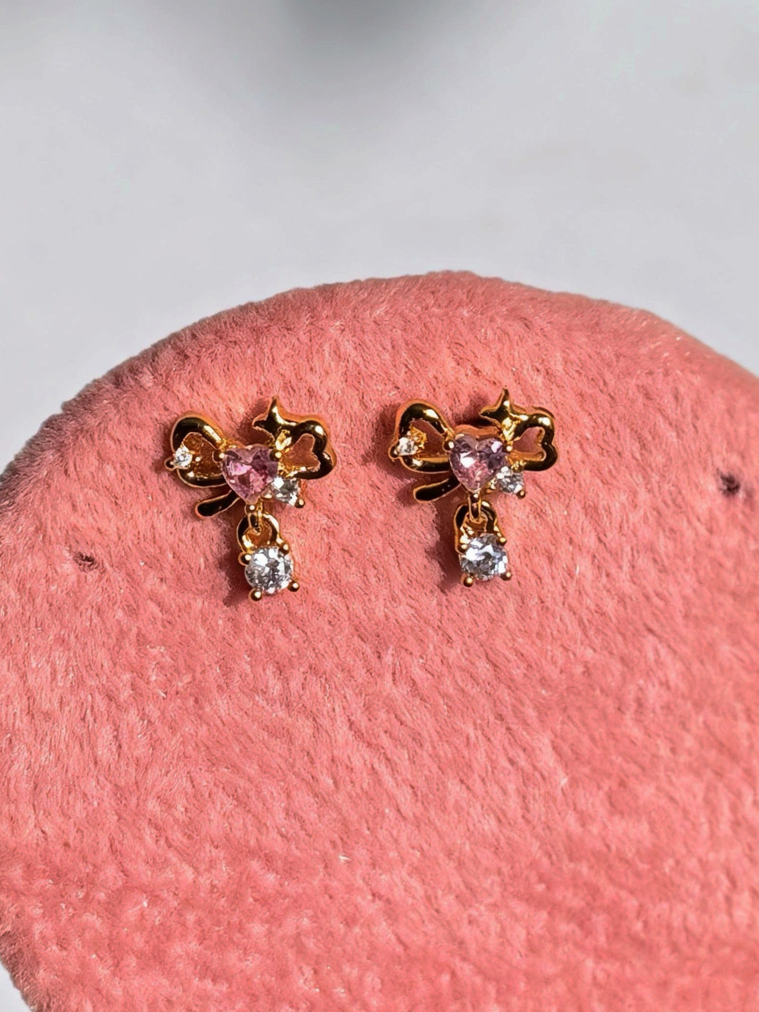 Pair of gold-plated bow studs �? sweet minimal bow earrings styled for everyday and casual wear, gifting.