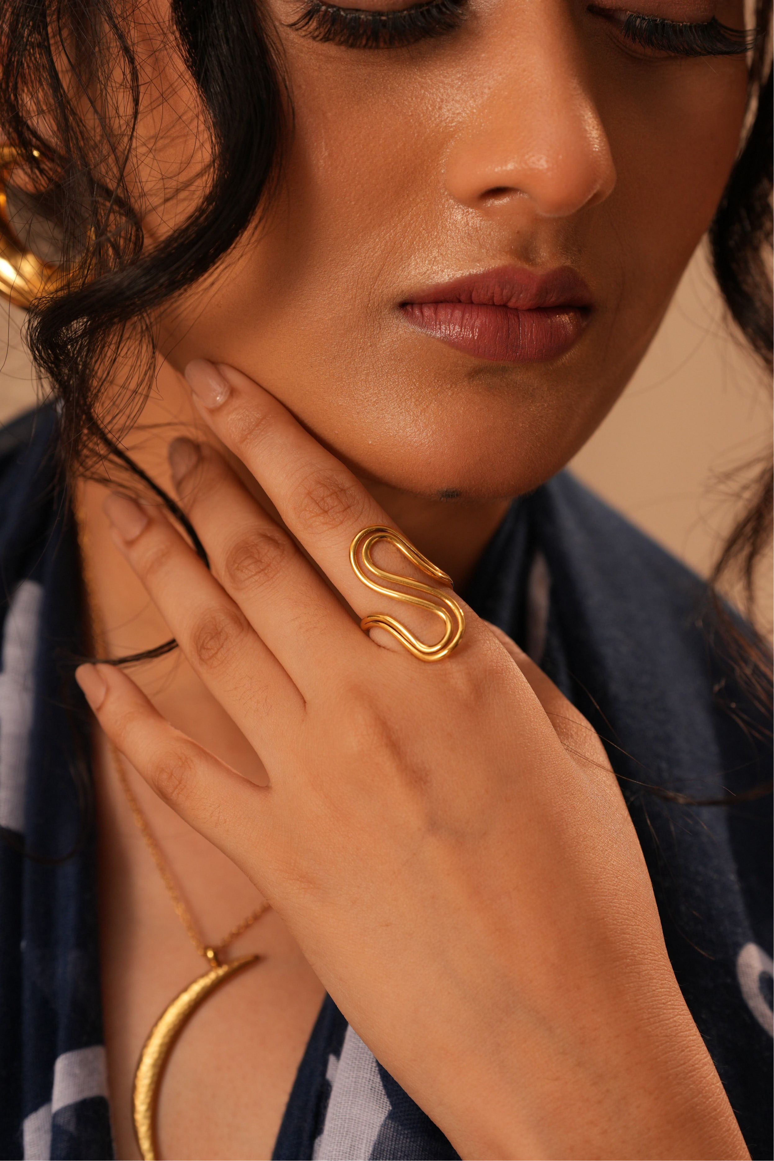 Twirl ring displayed �? 18k gold-plated minimal resizable twirl ring for casual styling.