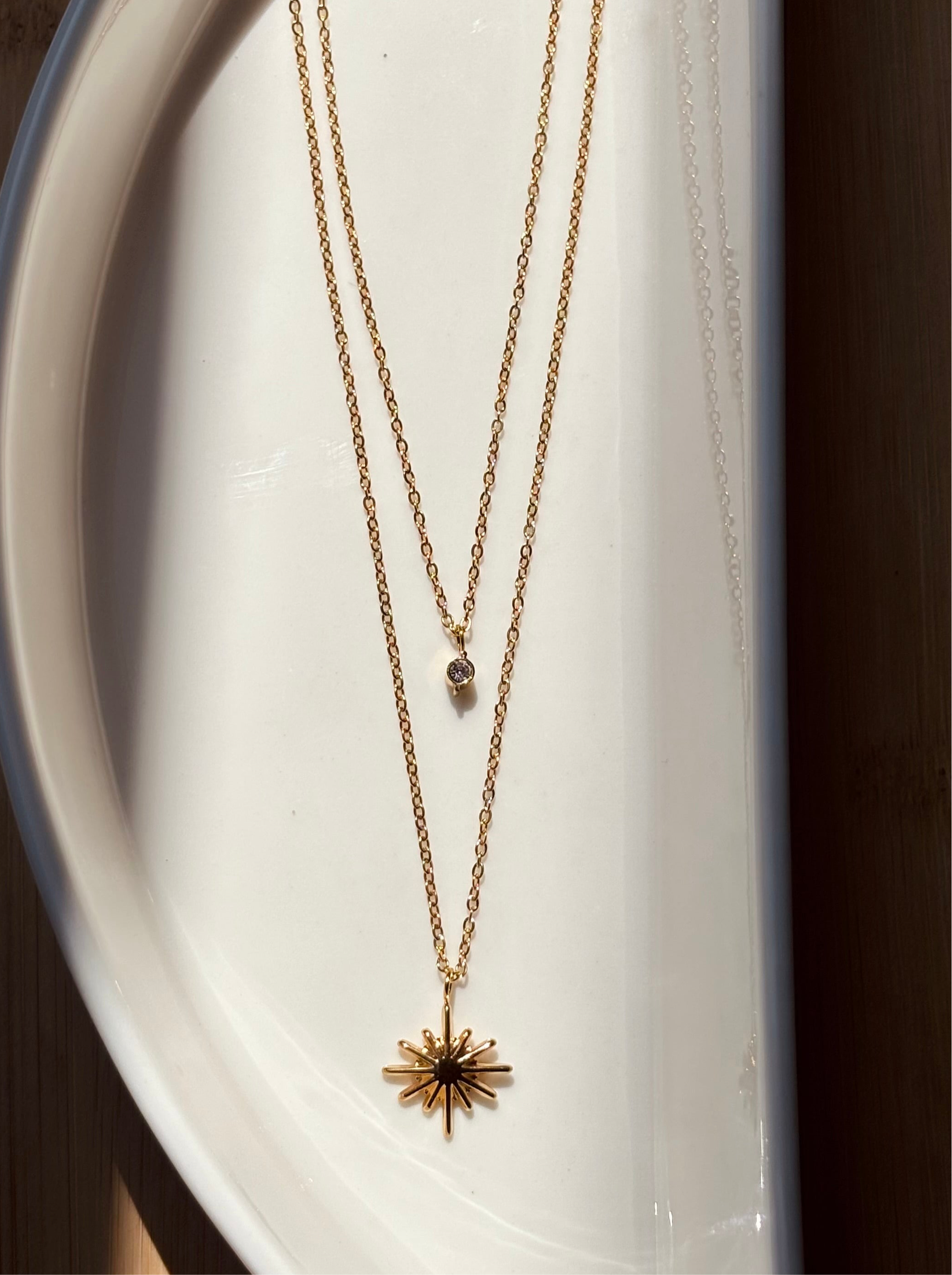 Close-up of double layer sun chain �? 18k gold-plated radiant celestial sun necklace for evening wear.