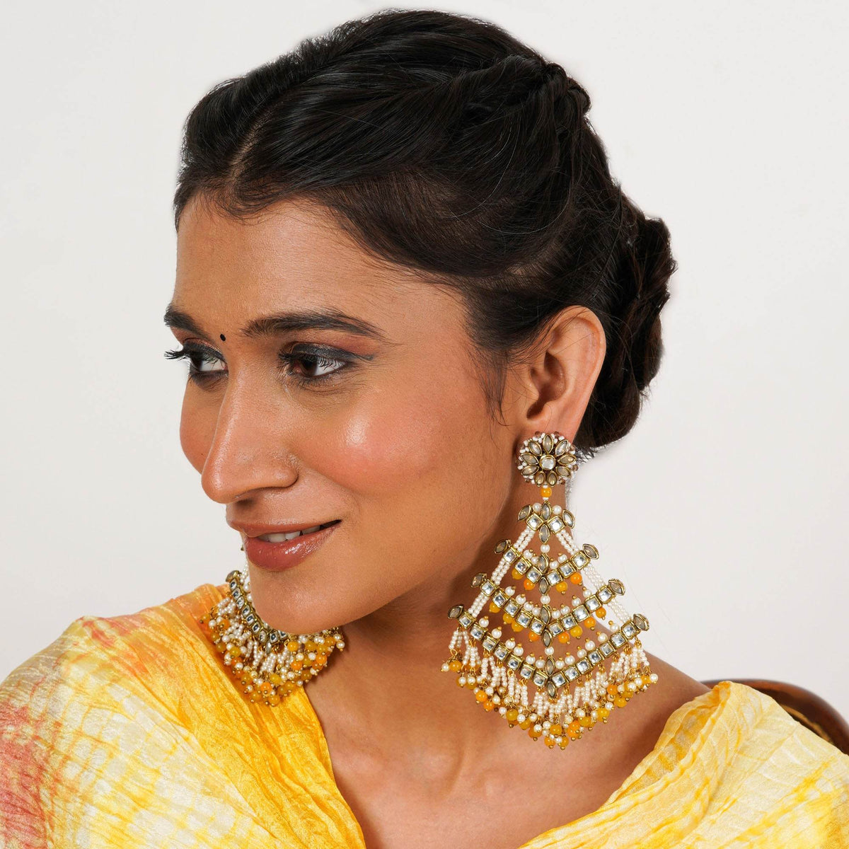 Traditional Kundan earrings in gold-tone, perfect for weddings and festive wear
