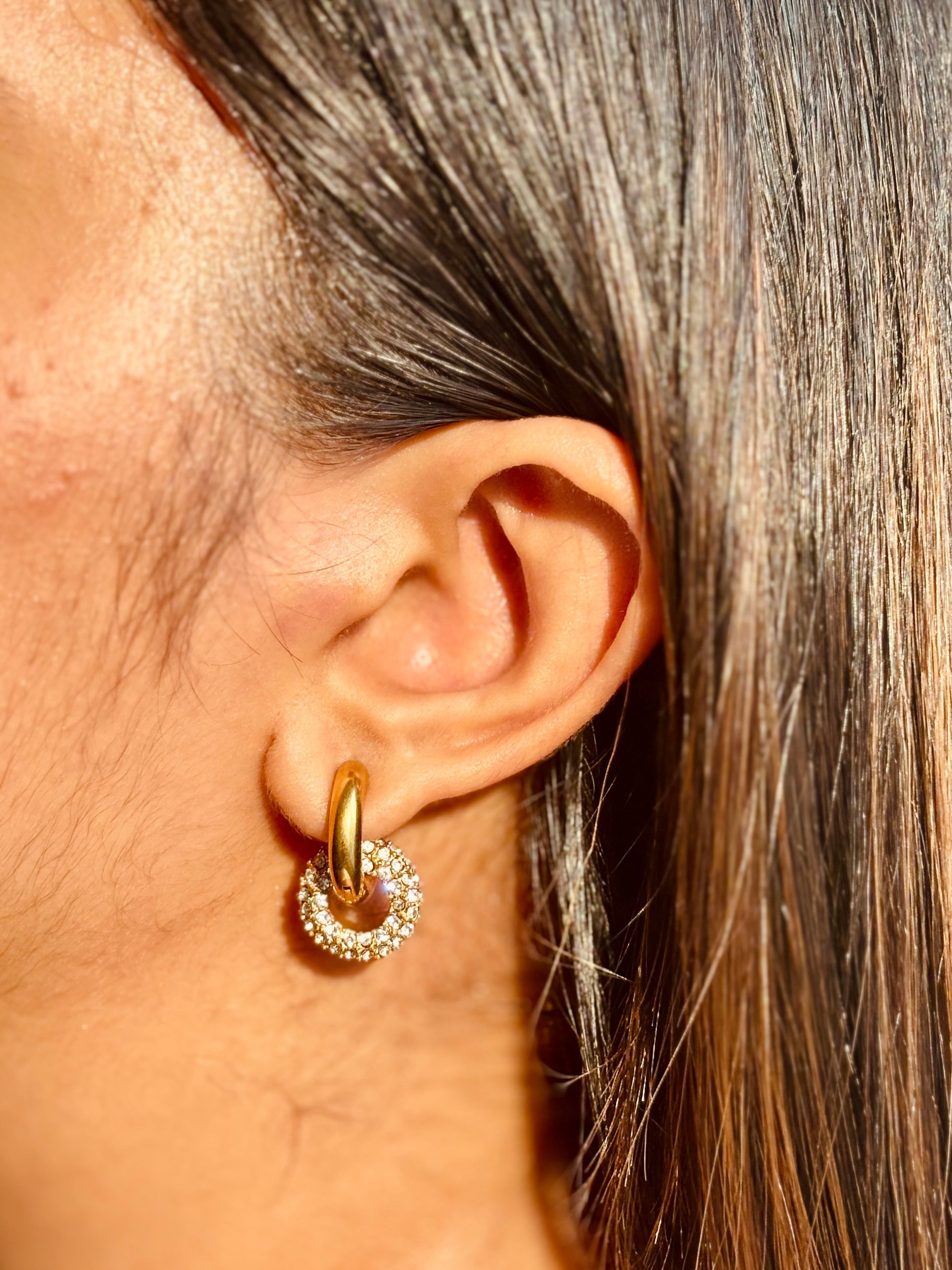 Gold-plated sparkle huggies with detachable white stone charm �? versatile hoops for everyday and evening.