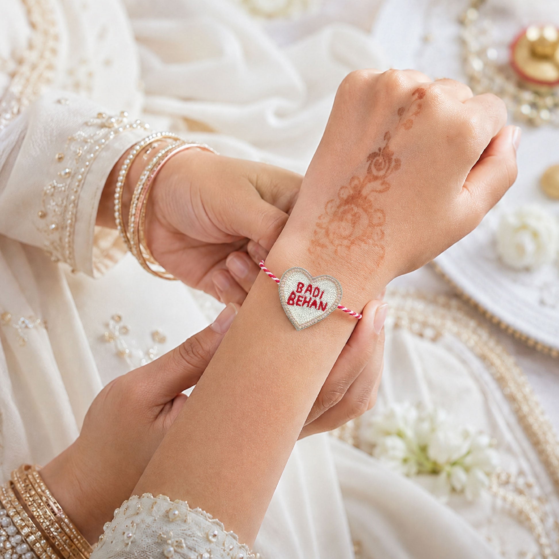 Red white braided thread rakhi with Badi Behan heart centerpiece