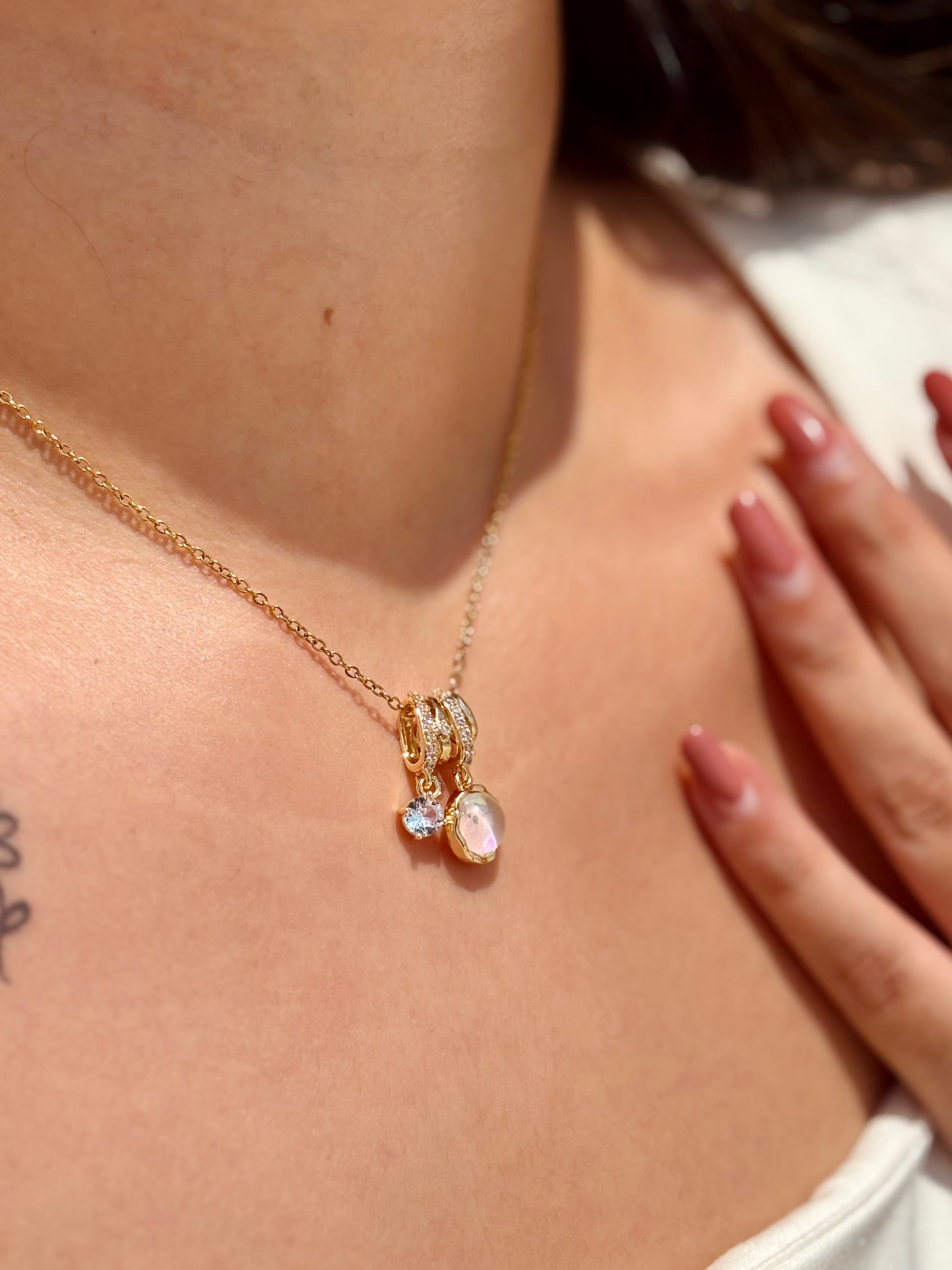 Close-up of Moon Bloom pendant �? chic moon gemstone charm on gold-plated chain for everyday wear.