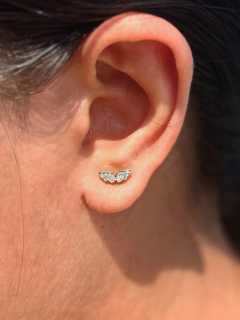 Close-up of wing ball-back stud earrings �? 18k gold-plated sleek wing studs for casual wear.