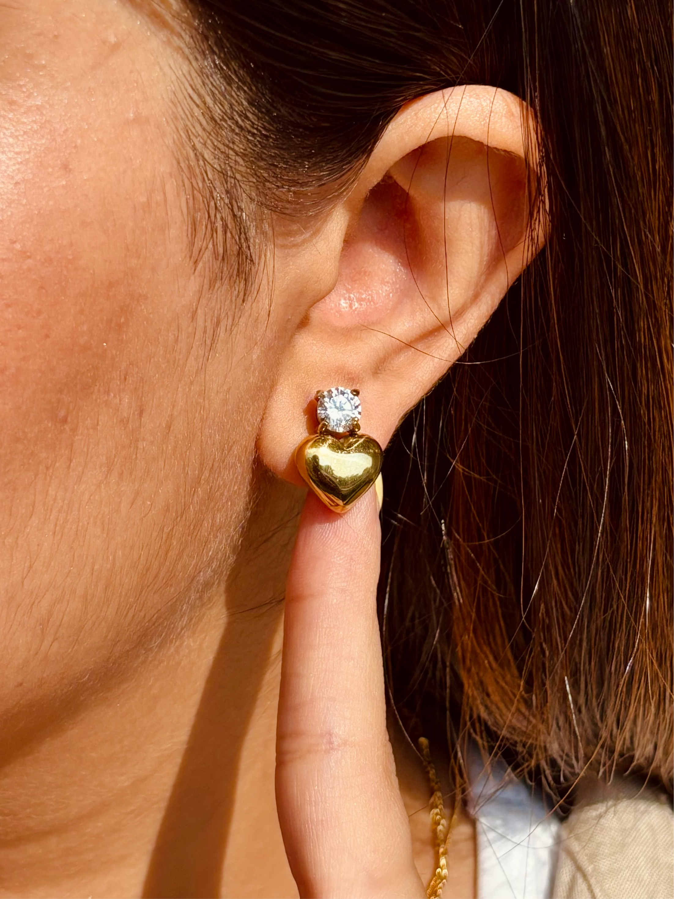 Close-up of heart stone stud earrings �? 18k gold-plated heart-shape design for casual styling and gifting.