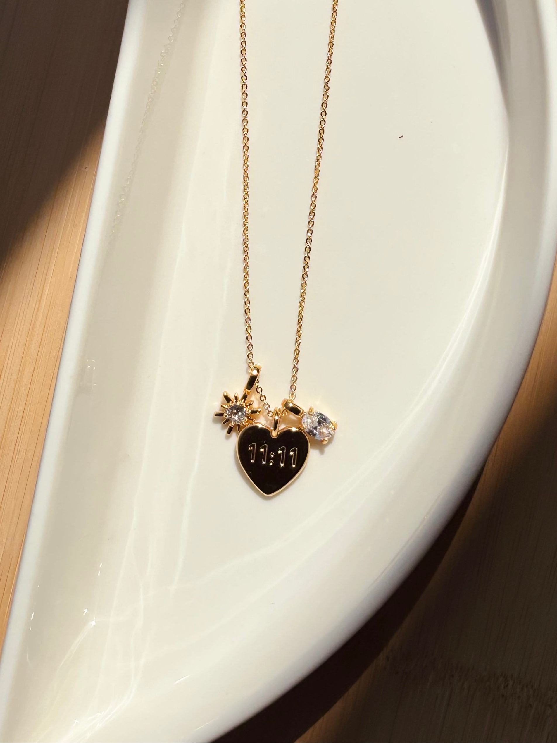 11:11 gold-plated charm necklace styled flat �? meaningful manifestation pendant for layering and gifting.