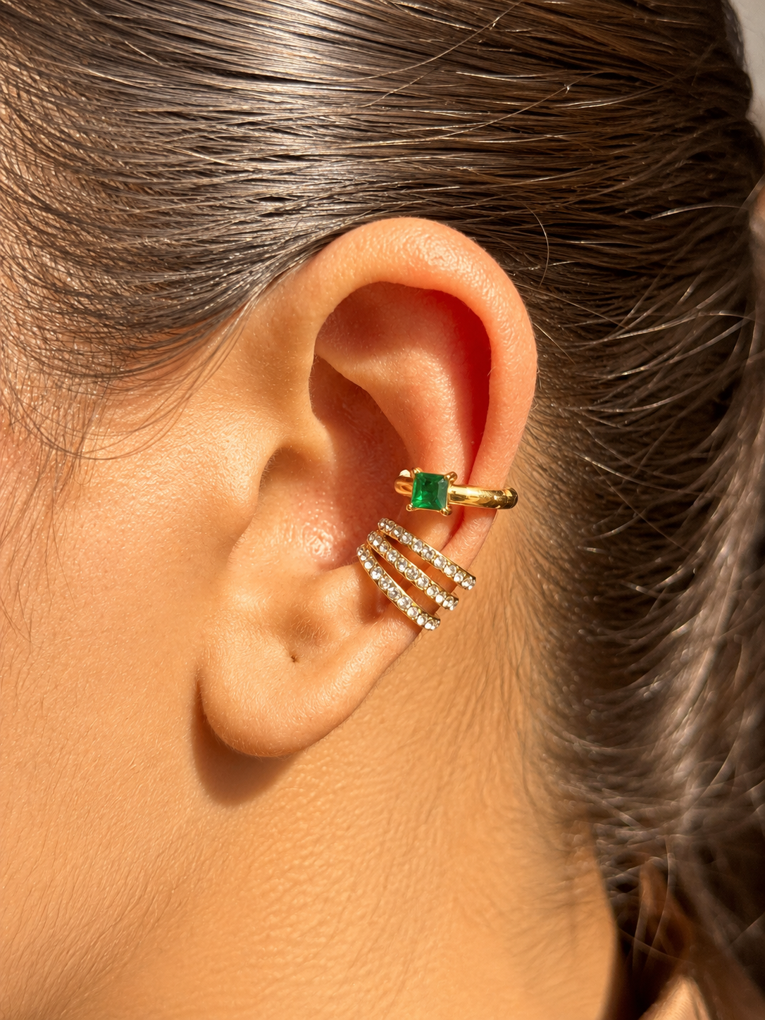 Close-up of Mira gold-plated ear cuff �? sleek 18k gold-plated statement no-piercing single-piece cuff.