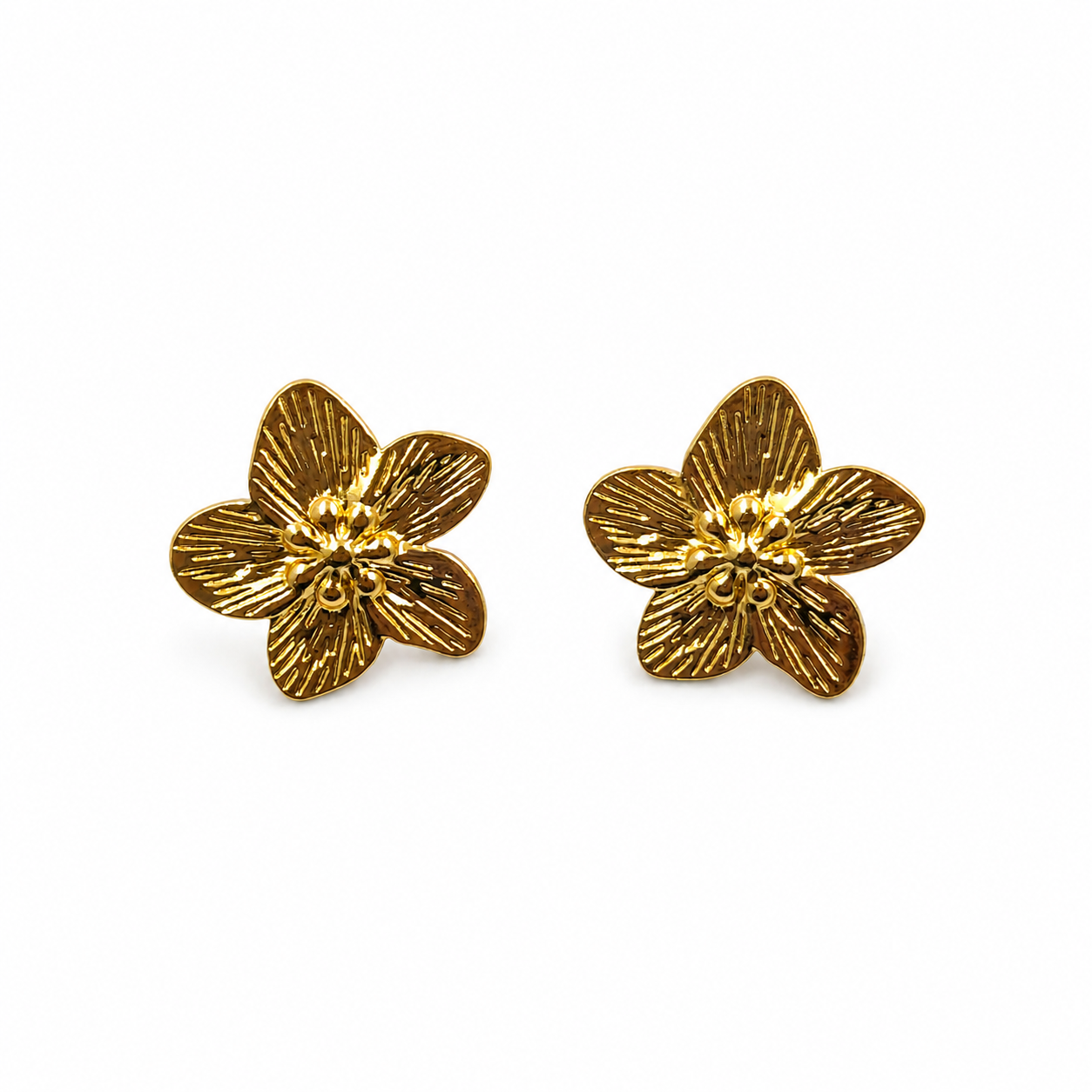Gold textured flower stud earrings pair on white background
