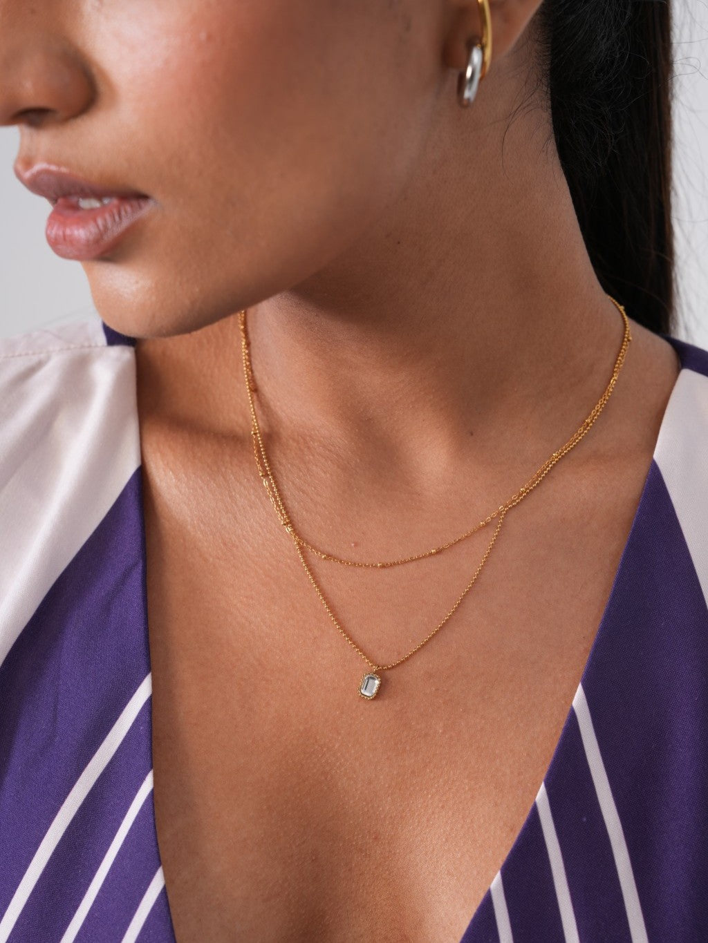 Close-up of double layer chain necklace �? 18k gold-plated stylish layerable necklace for casual wear.