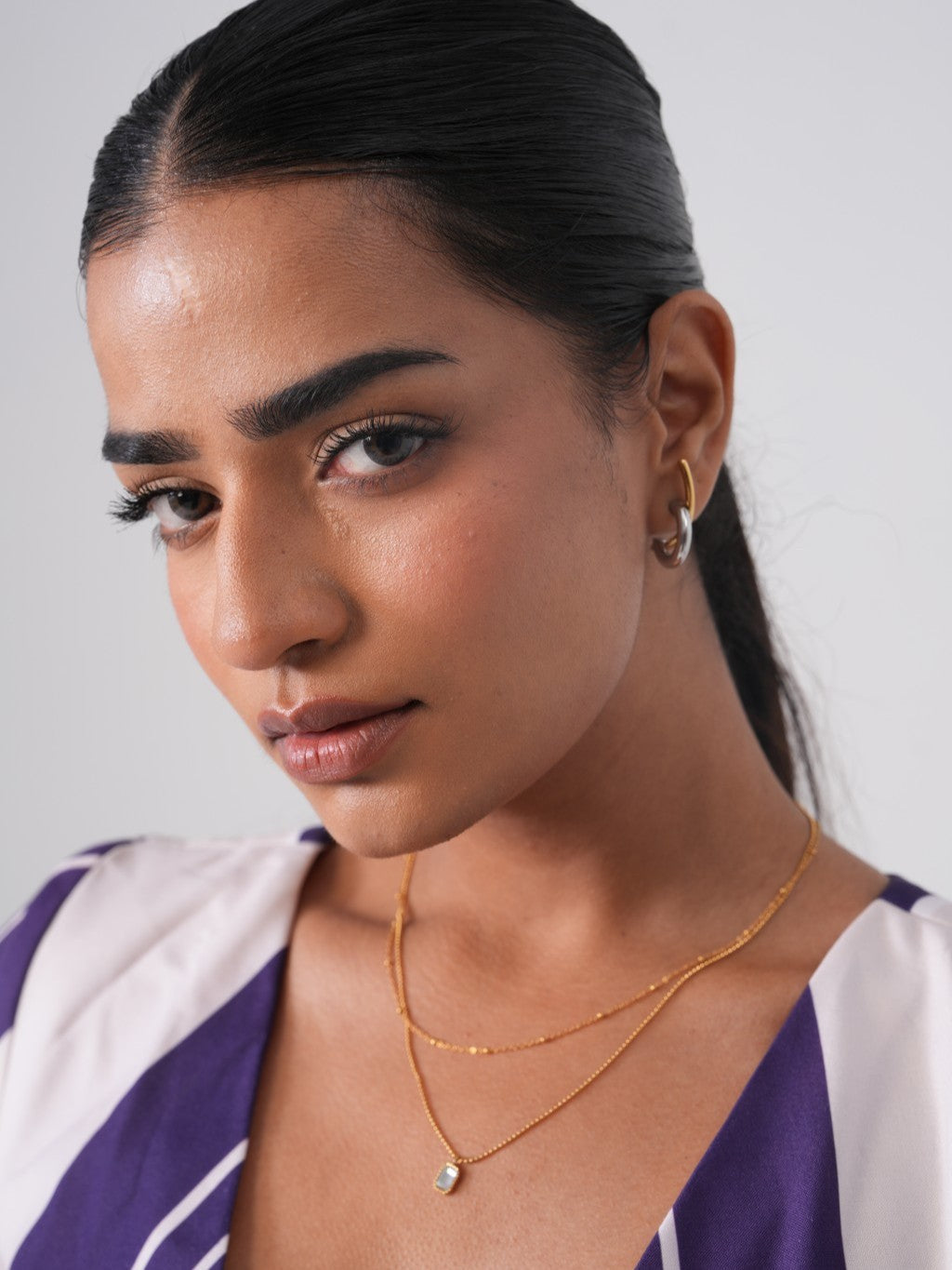 Double layer chain necklace displayed �? 18k gold-plated stylish double-layer necklace for evening looks.