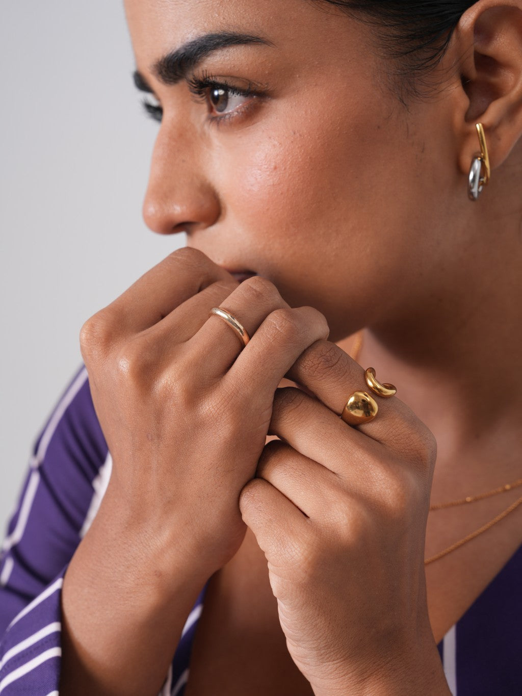 Detail shot of illusion drop earrings �? mixed metal 18k gold-plated drops for everyday and evening looks.