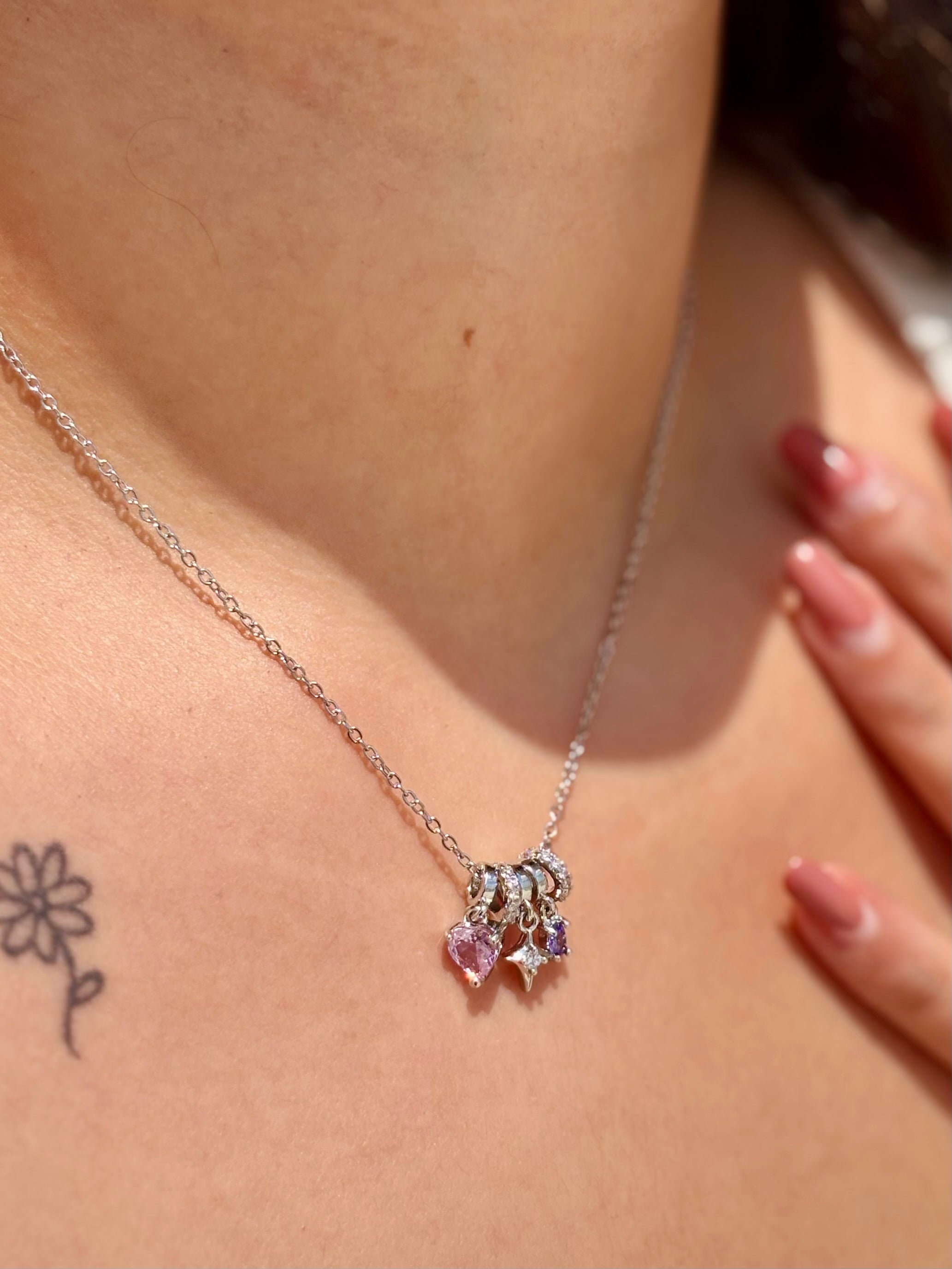 Close-up of Heart Bloom silver pendant �? chic gemstone heart charm on silver-finish chain for festive looks.