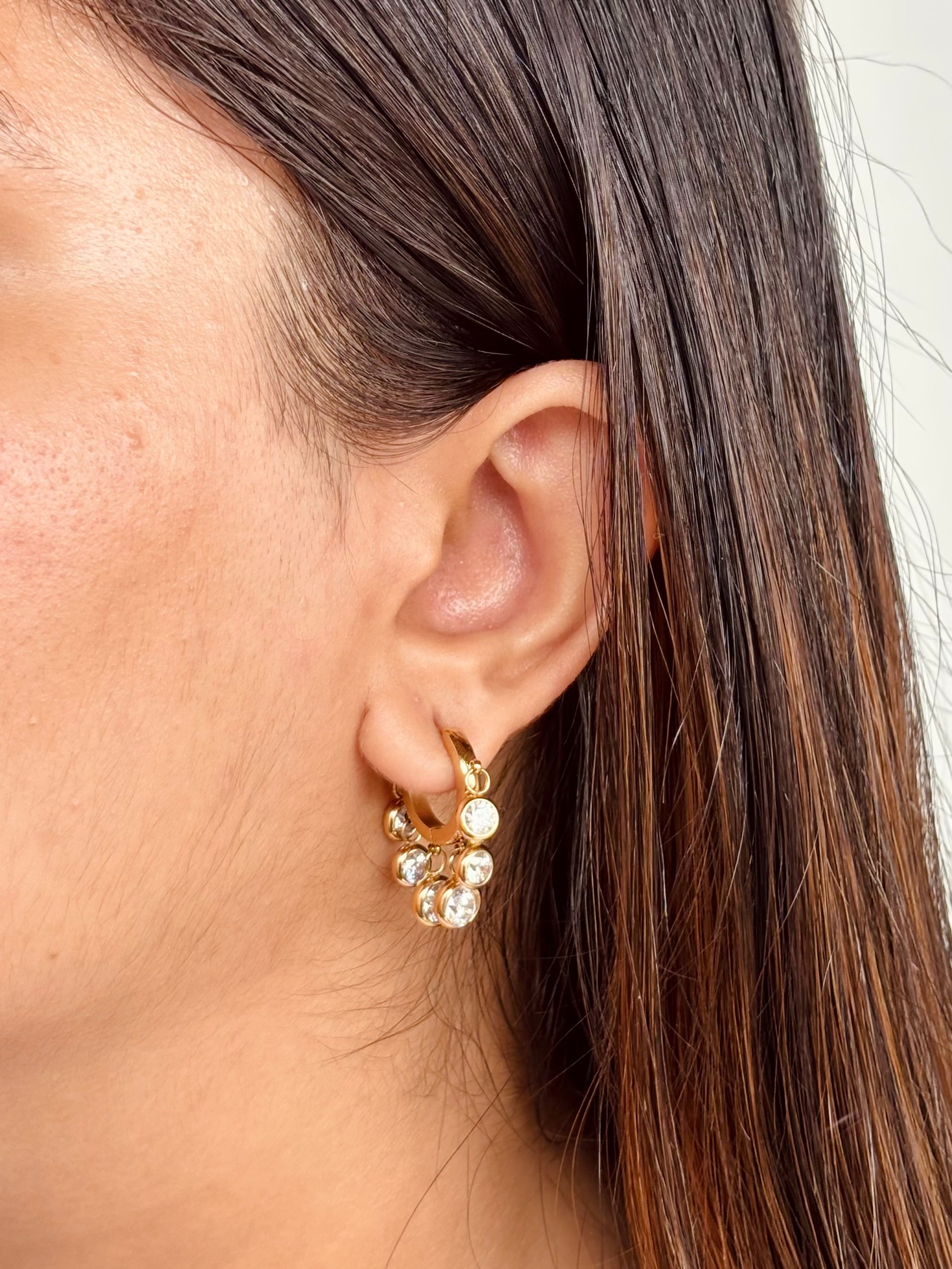 Gold-plated Daily Dazzle hoop earrings displayed flat �? waterproof, gifting-ready hoops for any occasion.
