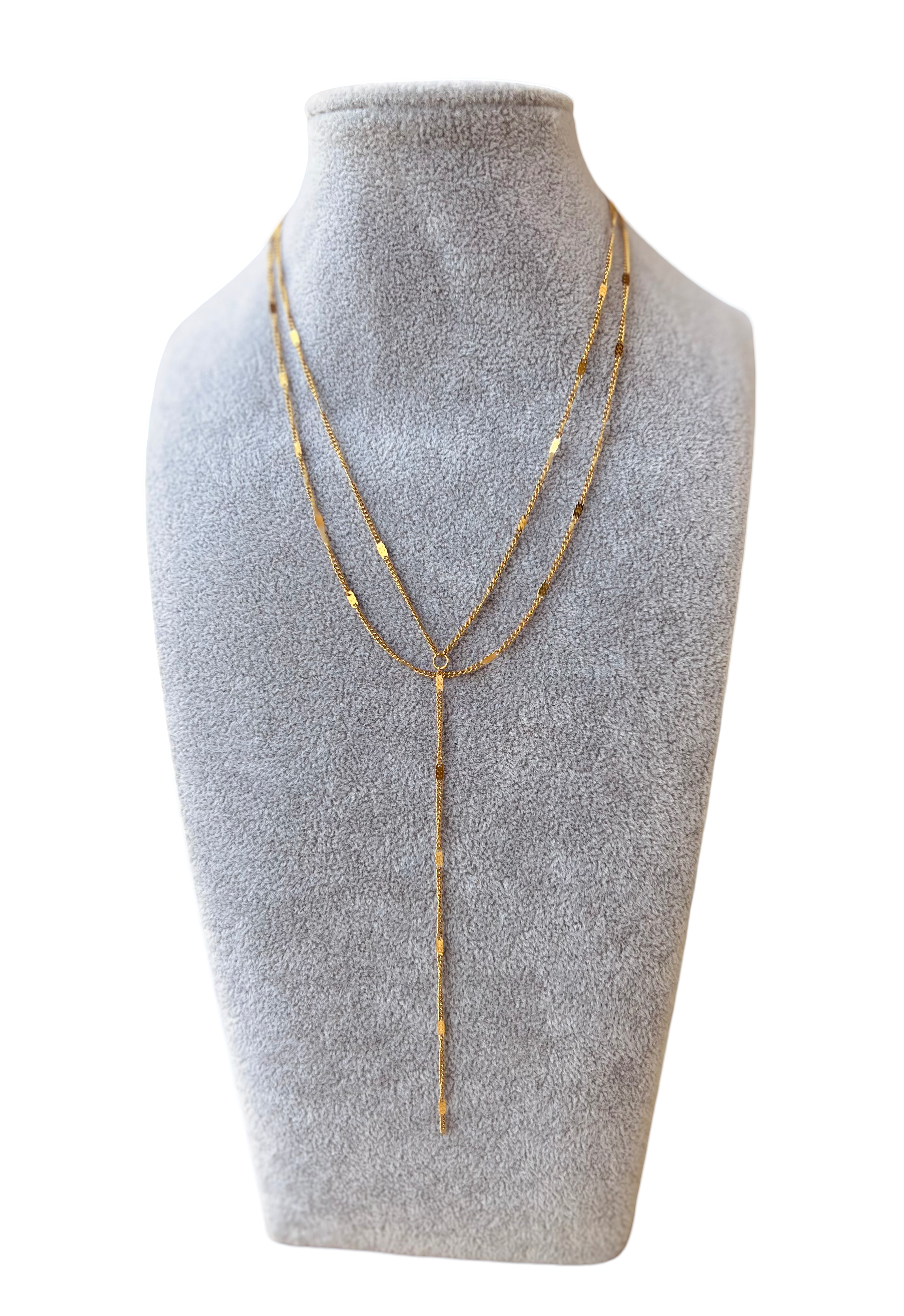 Close-up of Lariat necklace �? 18k gold-plated chic deep-neckline lariat for evening wear.