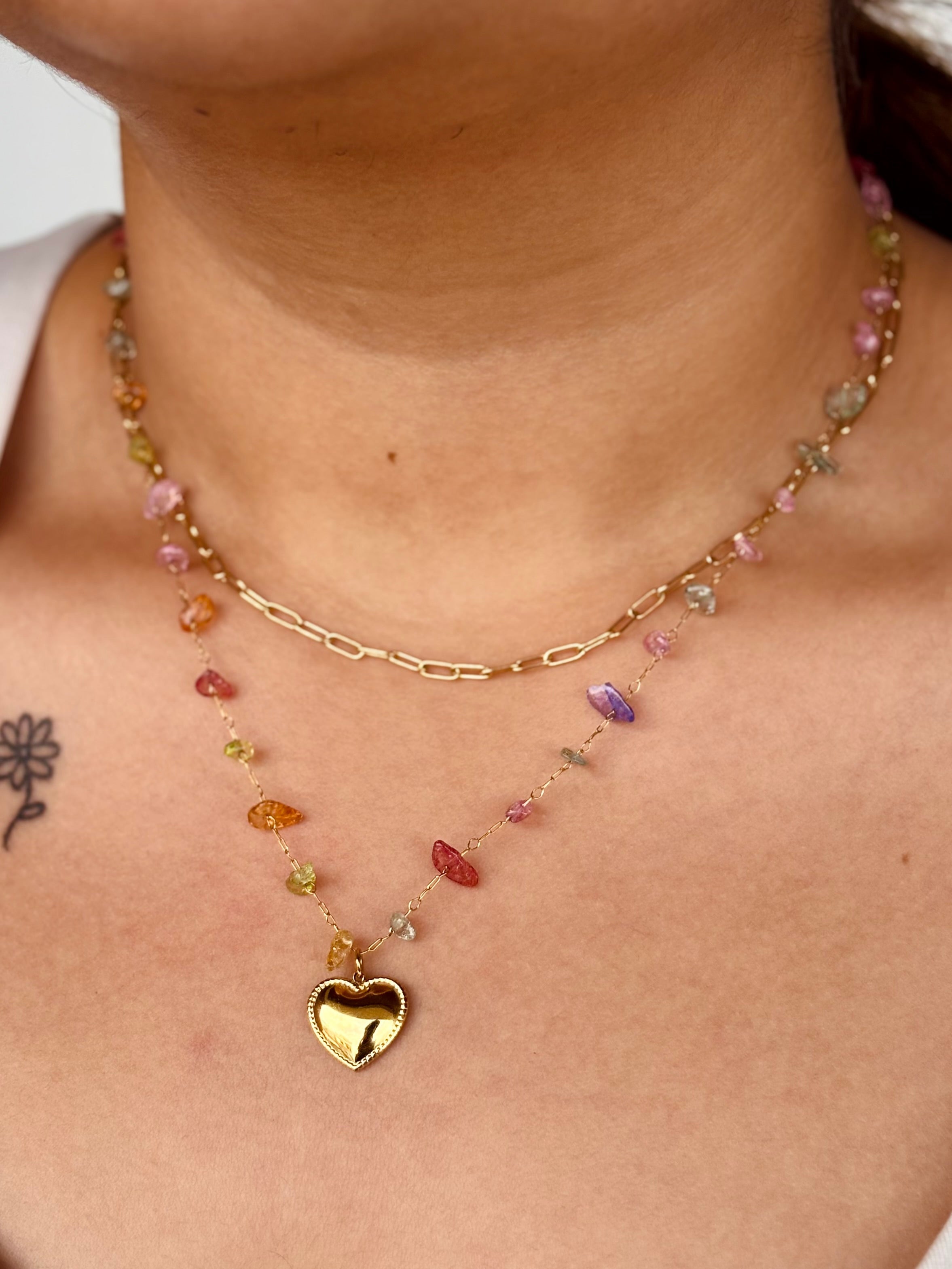 Gold-plated Vaira layered necklace displayed flat �? playful rainbow charm chain for gifting and everyday wear.