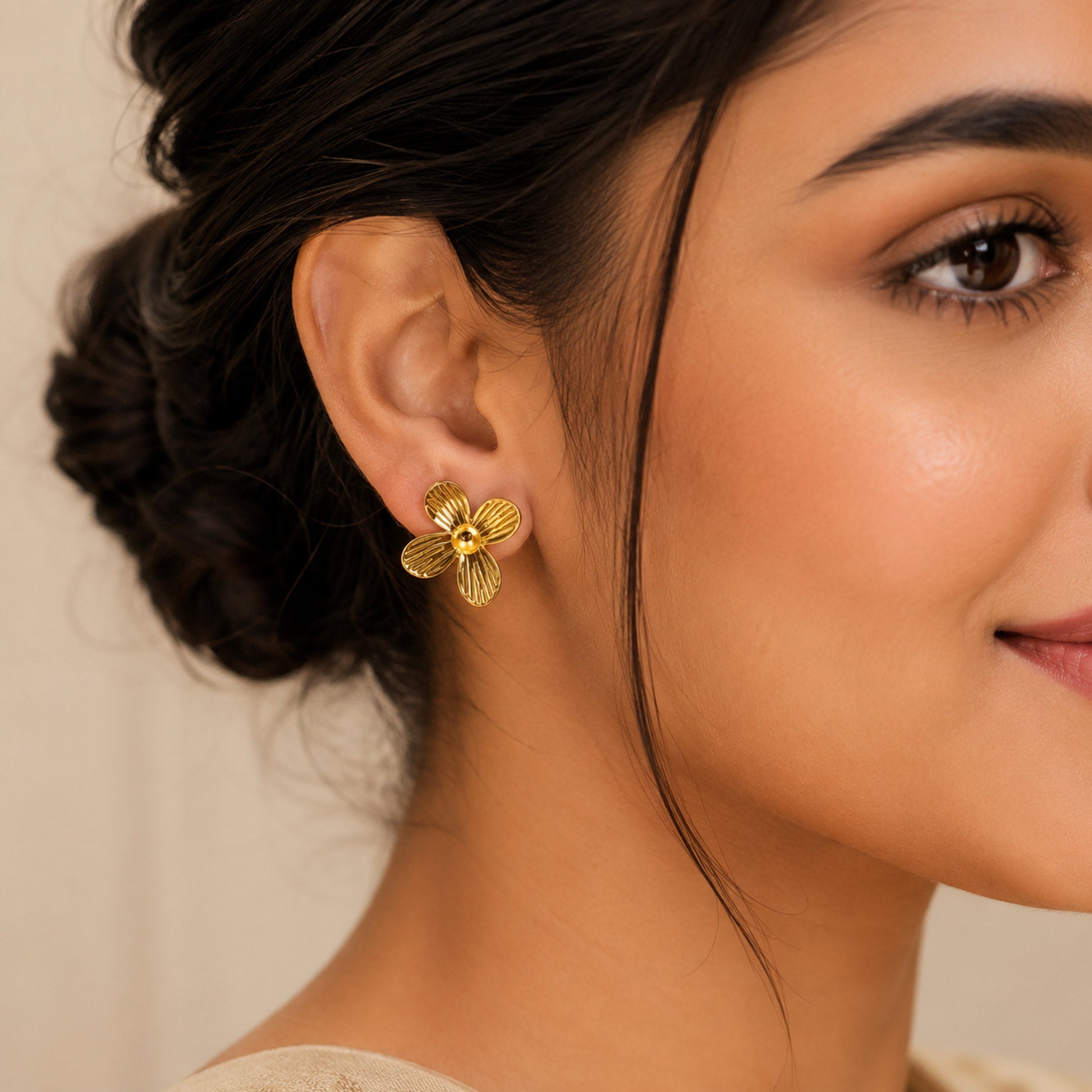 Gold flower earrings styled as elegant fashion jewellery for women