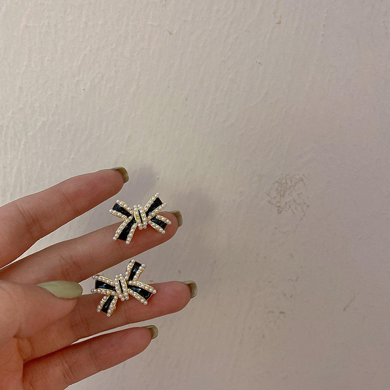 astria-jewellery-black-cross-bow-statement-earrings-for-women-gold-plated-crystal-studded-designer-earrings-bold-party-wear-fashion-jewellery